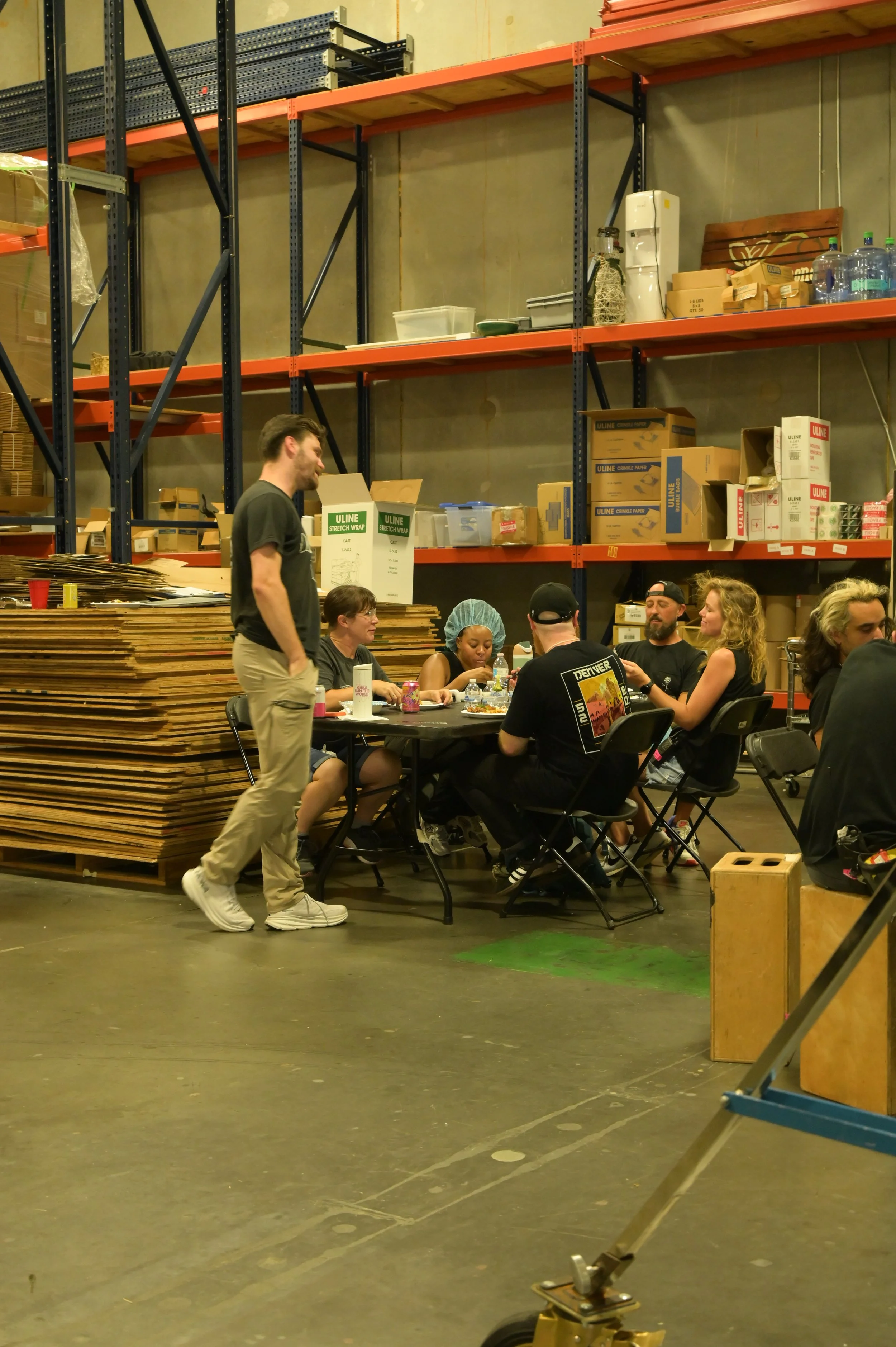 crew eating lunch in warehouse