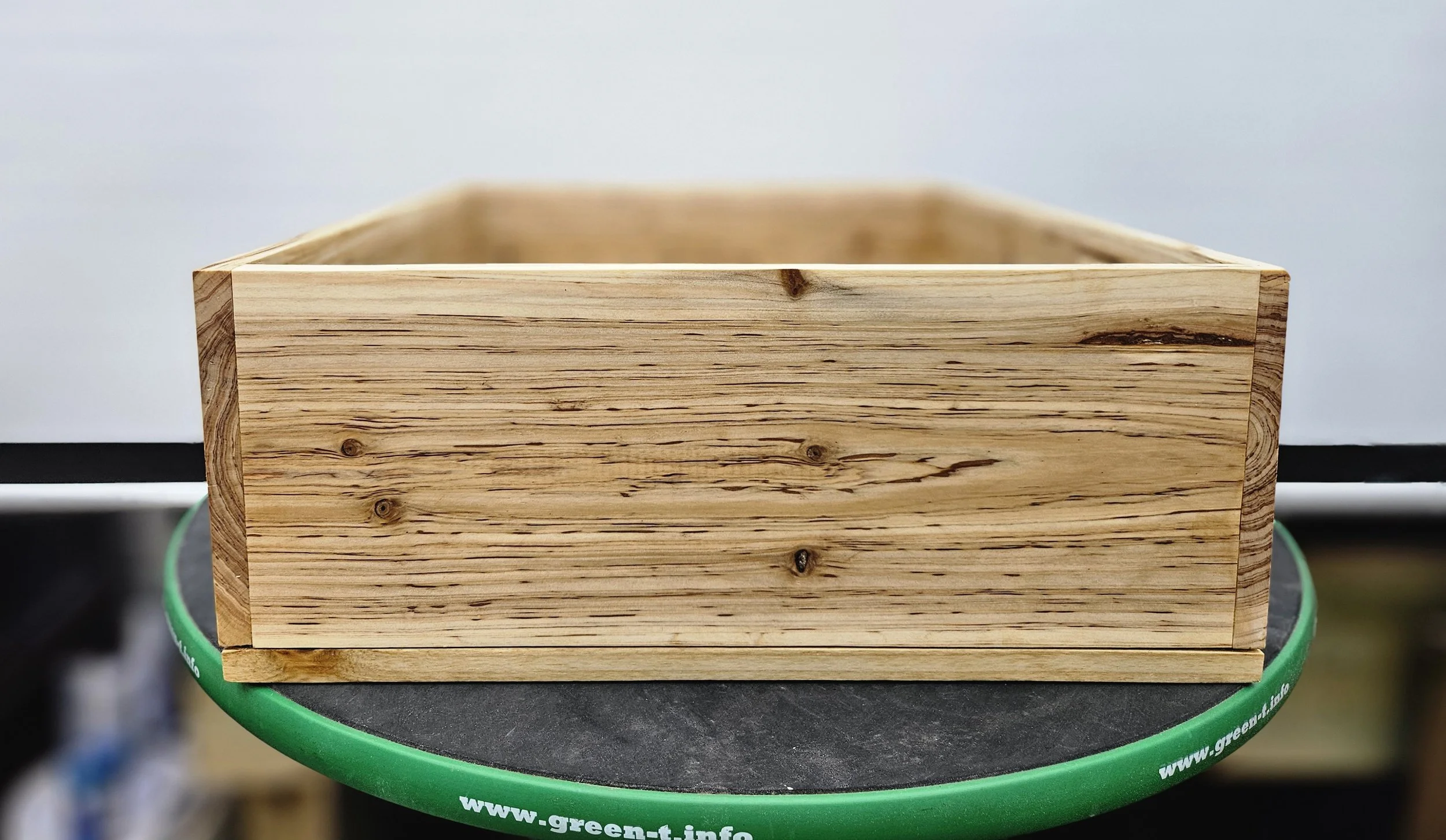Custom cedar bonsai grow box with raised feet for airflow and drainage beneath the container