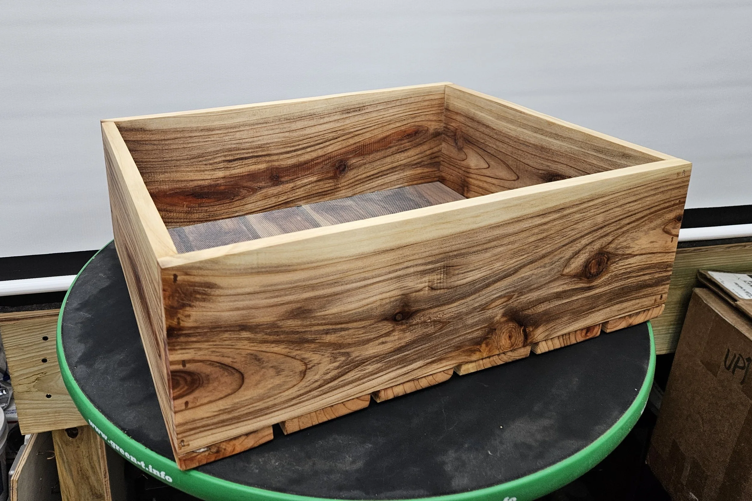 Handcrafted cedar bonsai grow box with natural wood grain and elevated slatted base