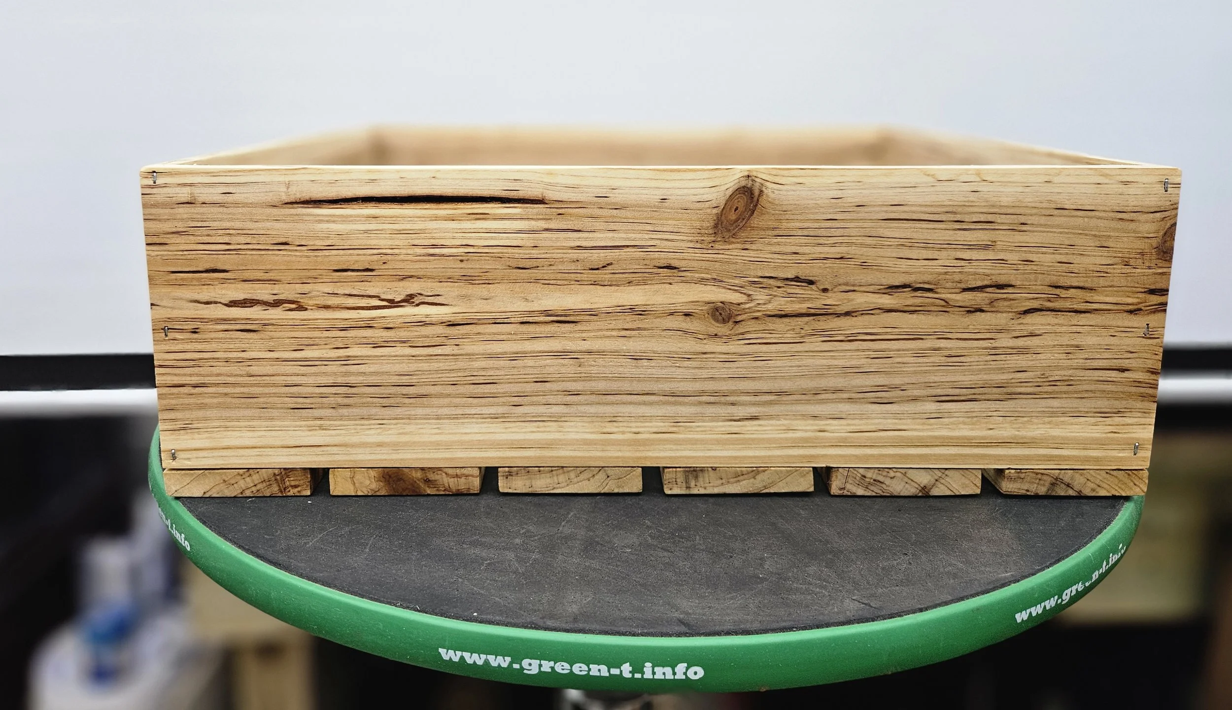 Custom cedar bonsai grow box with raised feet for airflow and drainage beneath the container