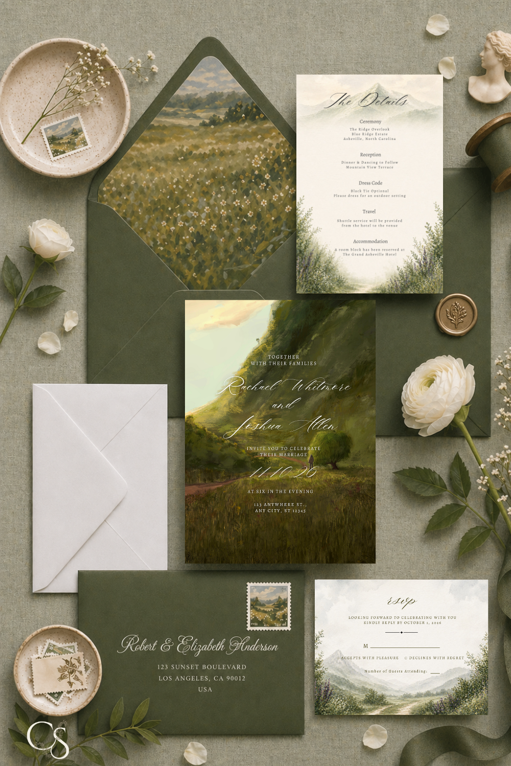 Luxury mountain wedding invitation suite with dramatic landscape artwork, deep green tones, elegant script typography, and coordinated RSVP and details cards in a styled flat lay.