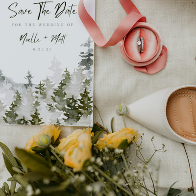 Nature-inspired save the date wedding card with greenery and soft romantic styling.