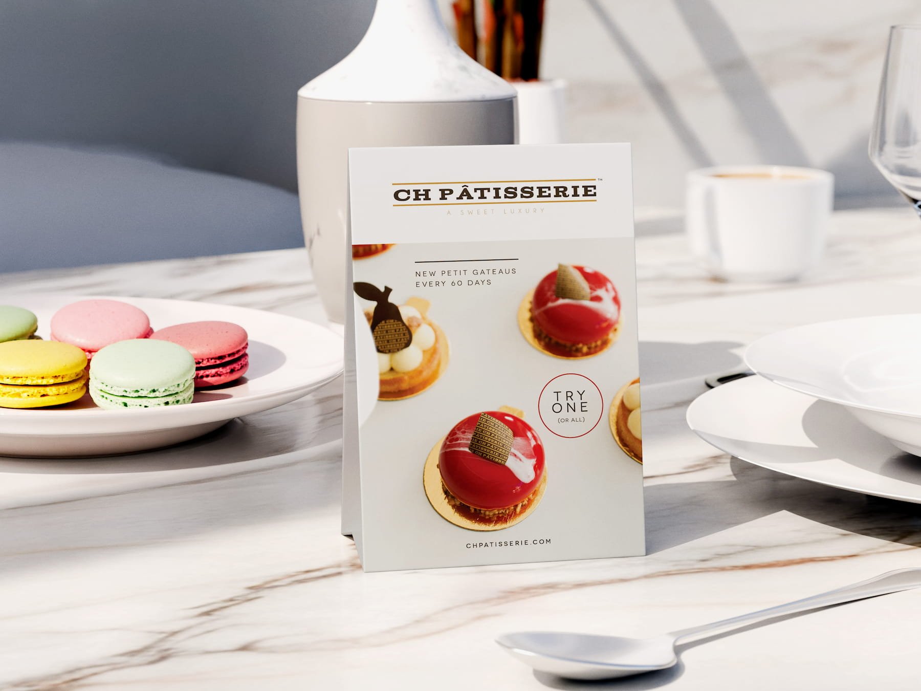 CH Patisserie table tent mockup with macarons in the background.