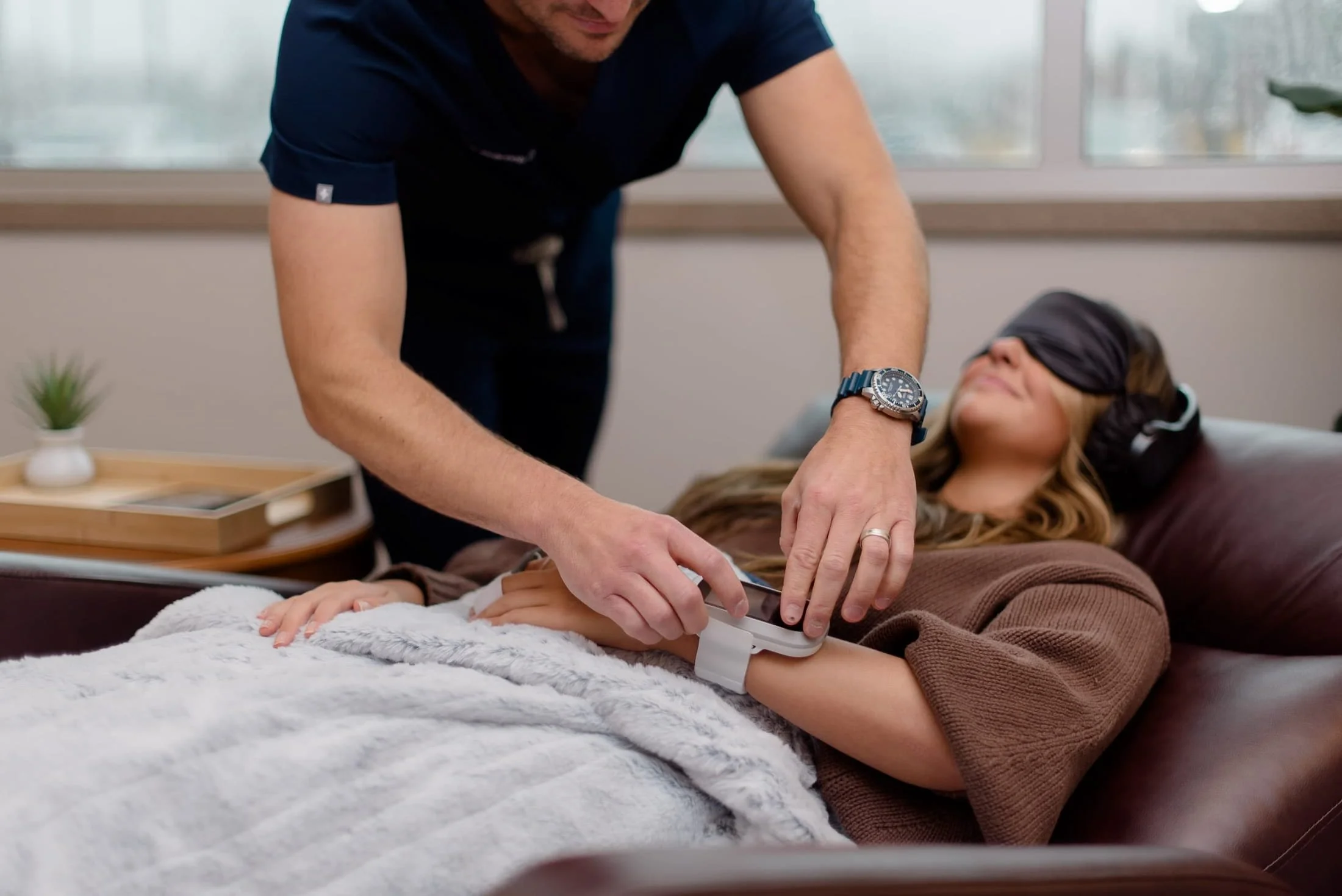 PAX Institute doctor giving treatment to patient.