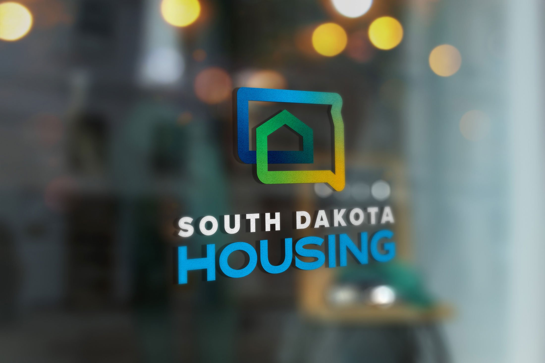 South Dakota Housing logo on glass door