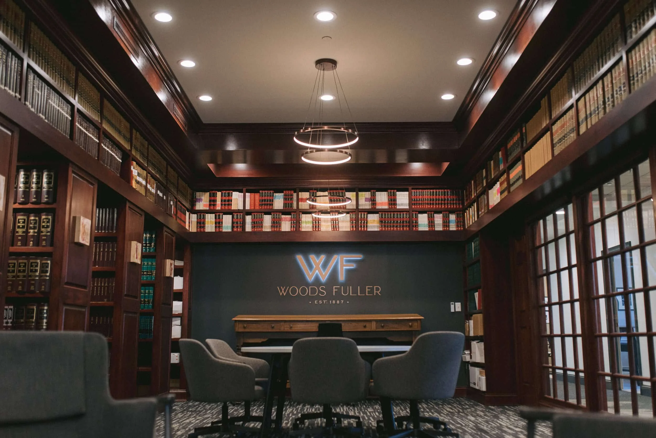 Woods Fuller legal library filled with books and a meeting table.