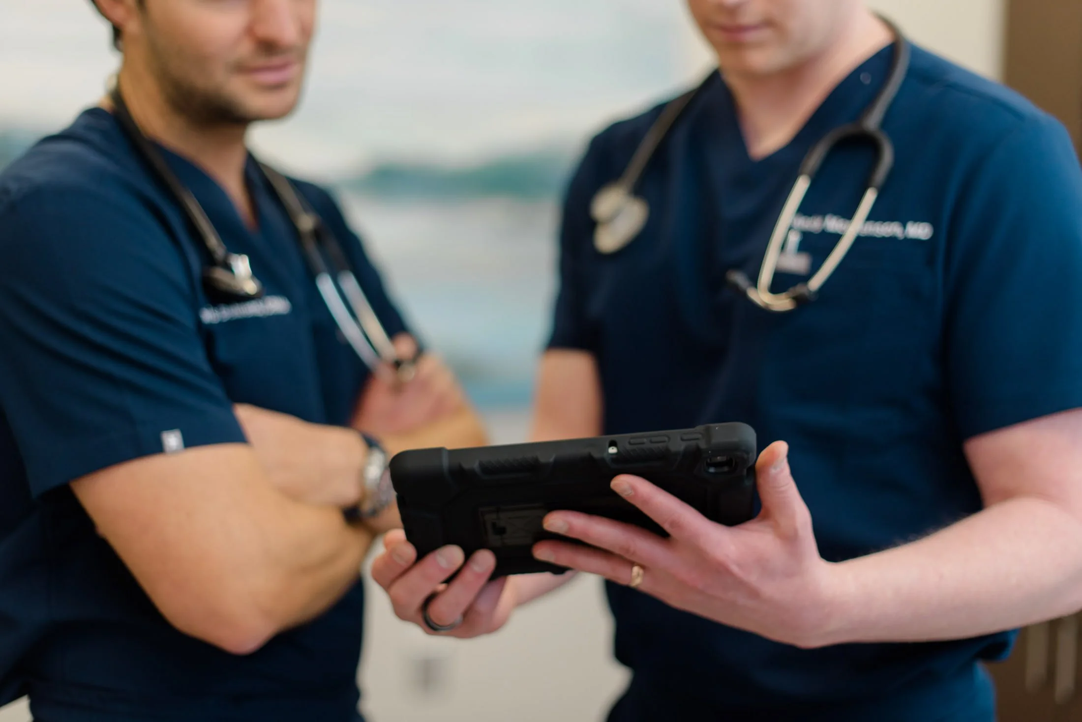 Two PAX Institute doctors looking at ipad.