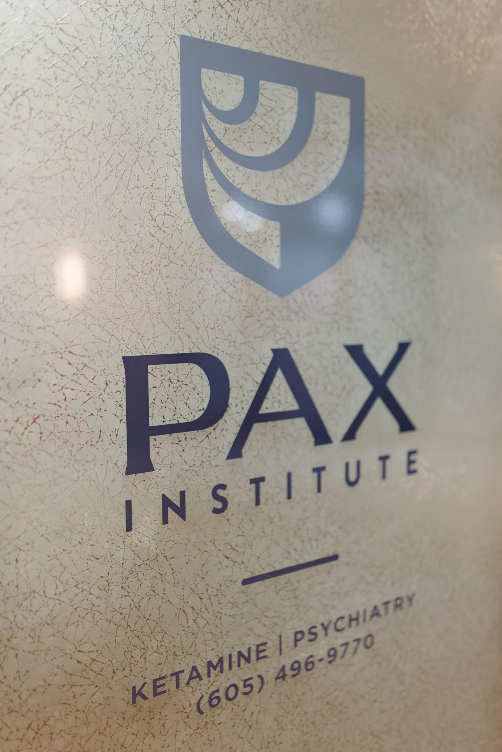 PAX Institute door window sign.