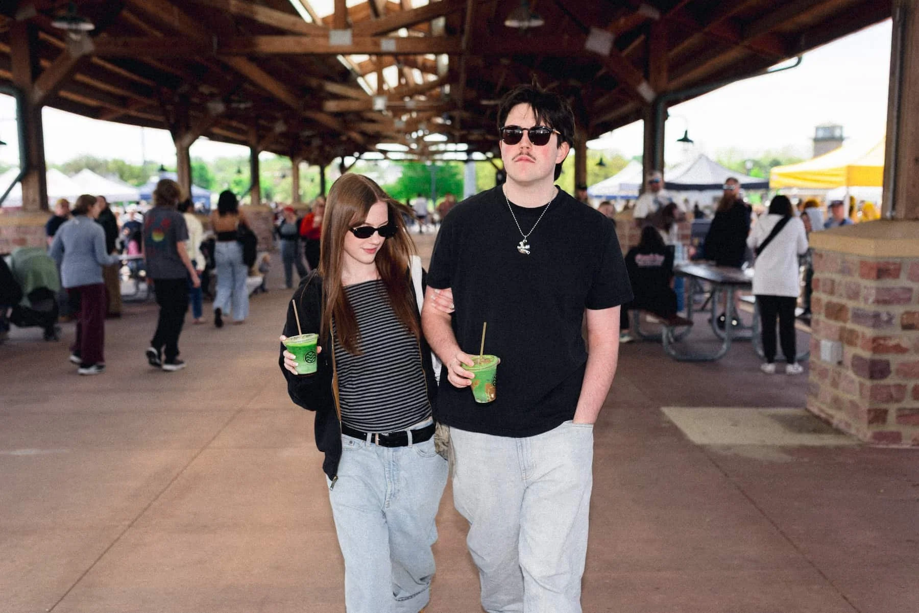 couple walking and holding matcha.