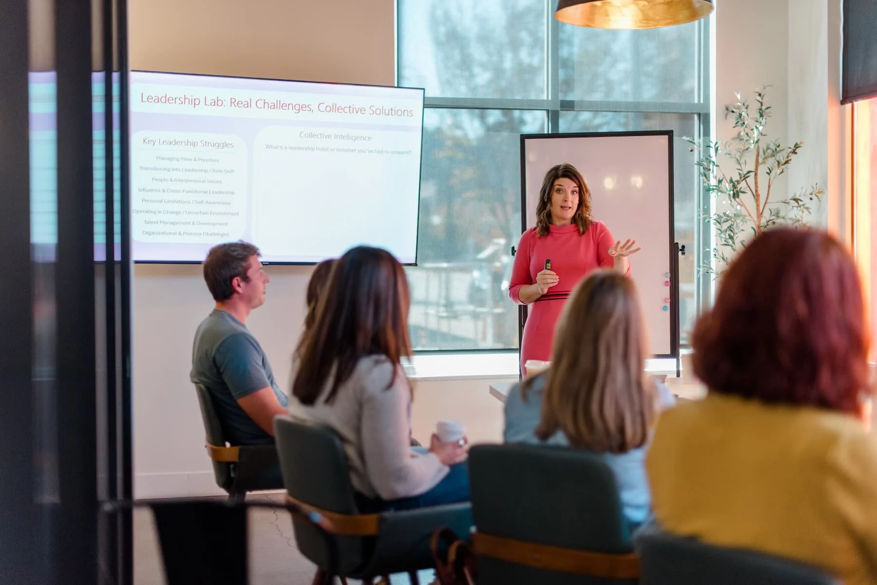 Lora Hayes giving a talk to group of people.