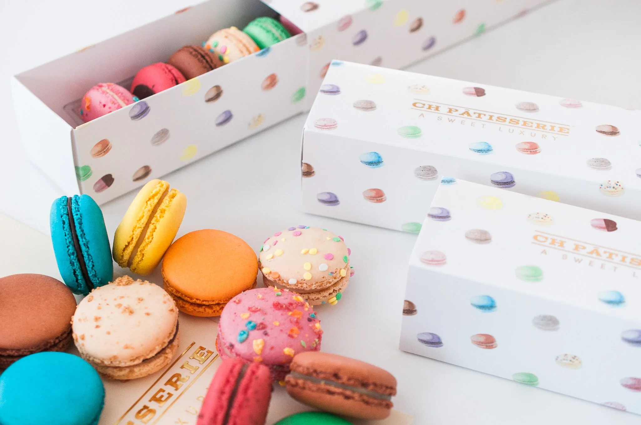 Boxes of multi colored macarons from CH Patisserie