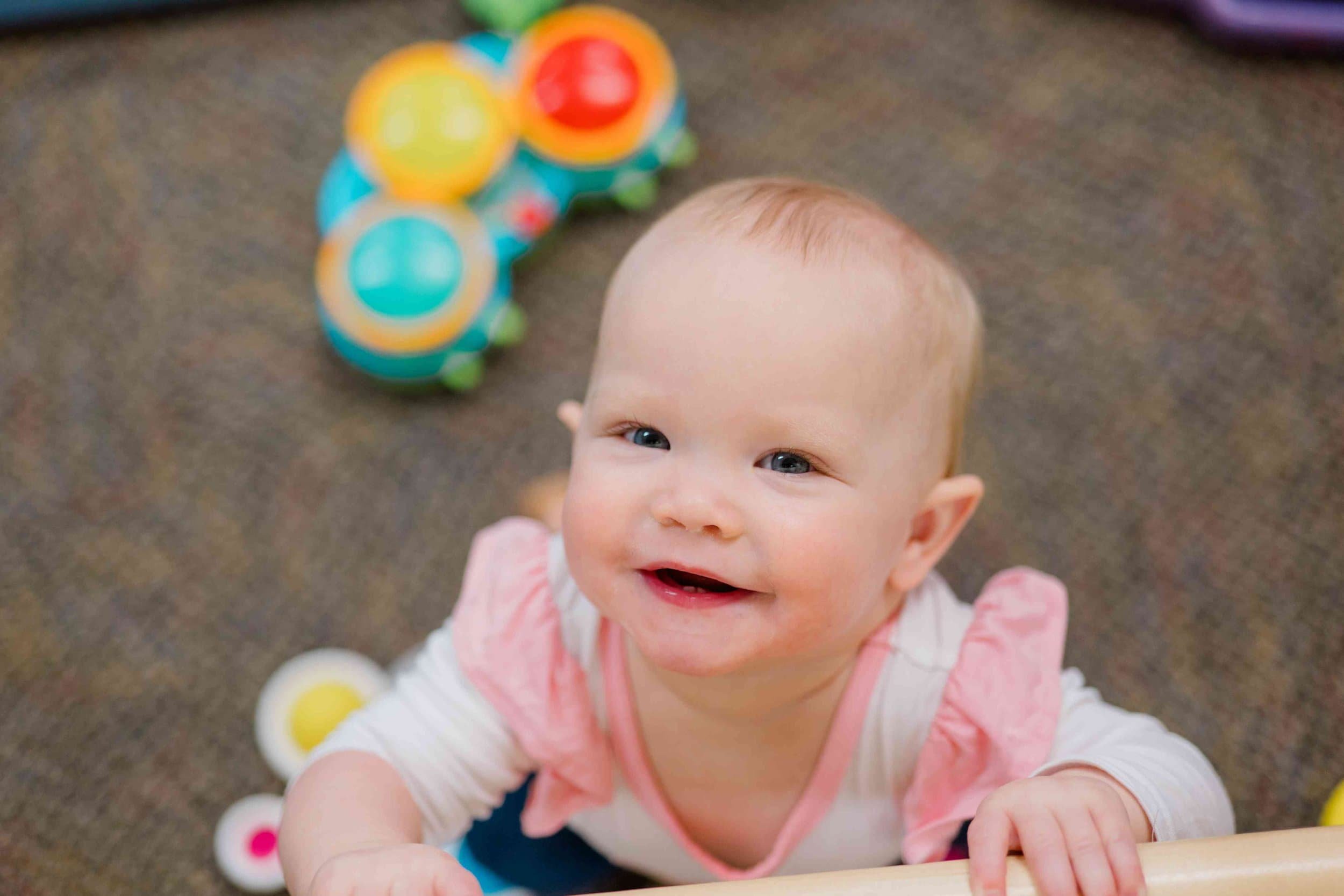 baby smiling at the camera.