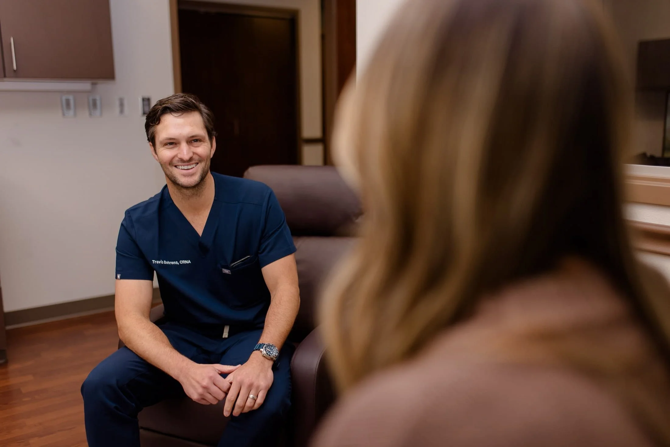 PAX Institute doctor smiling at patient.