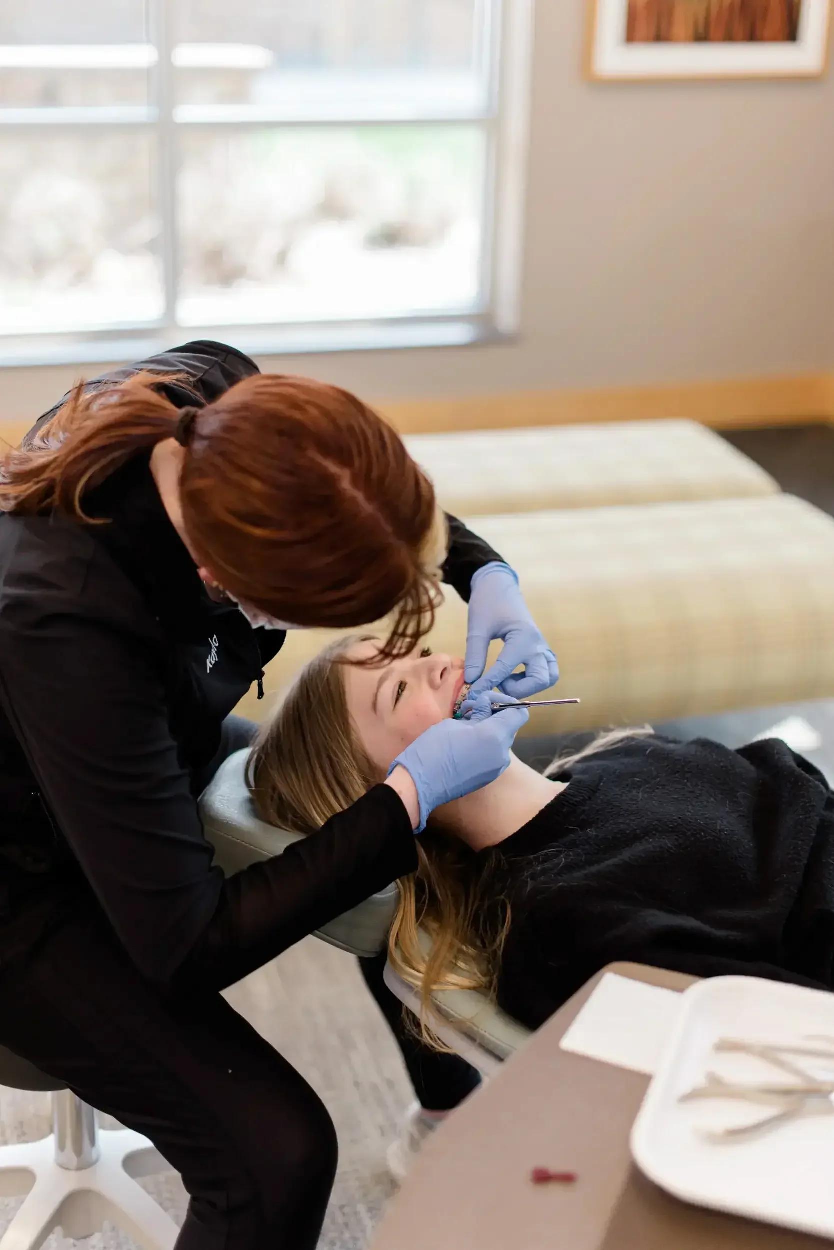 A dentist cleaning a patient's teeth