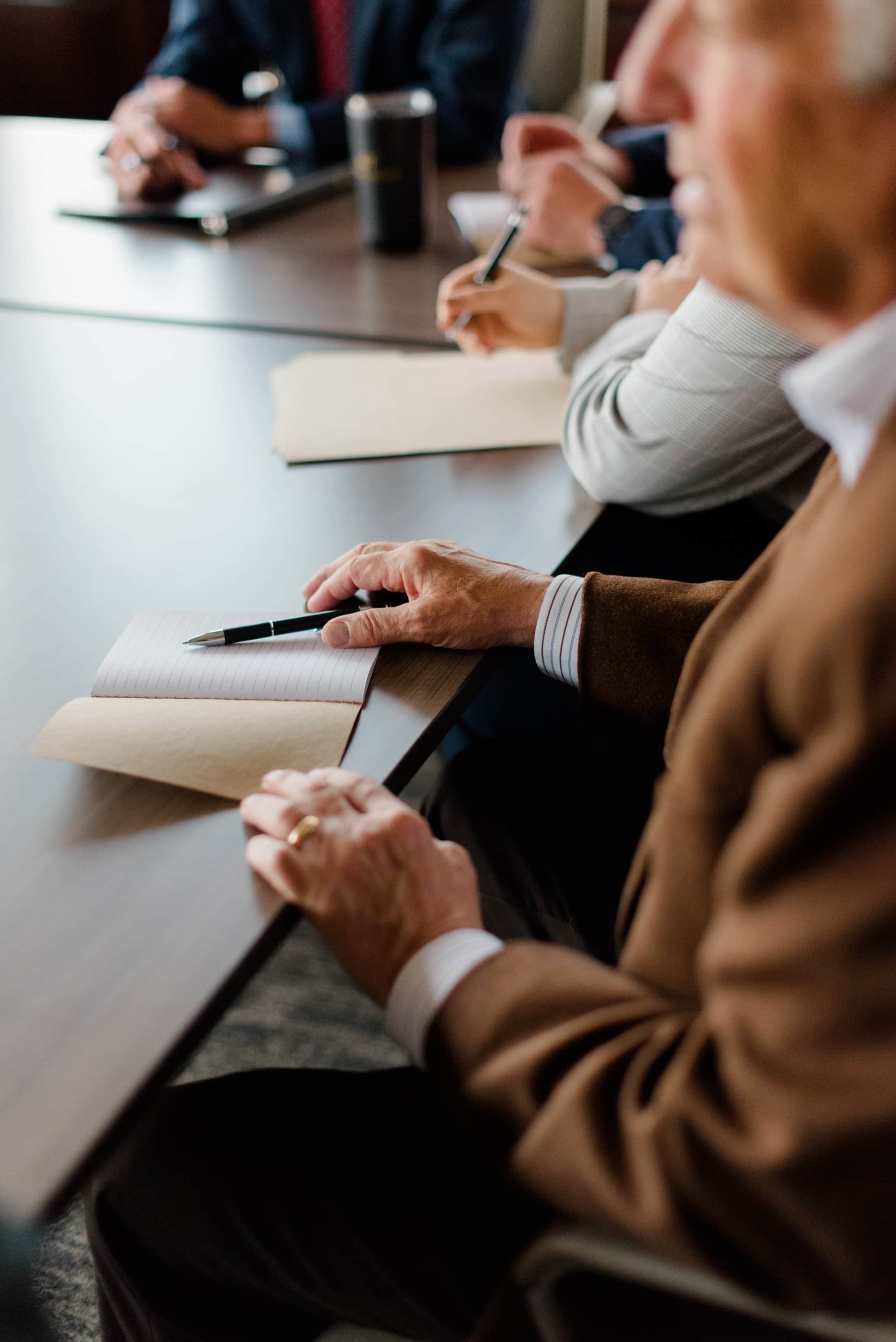 Man with notebook and pen on table
