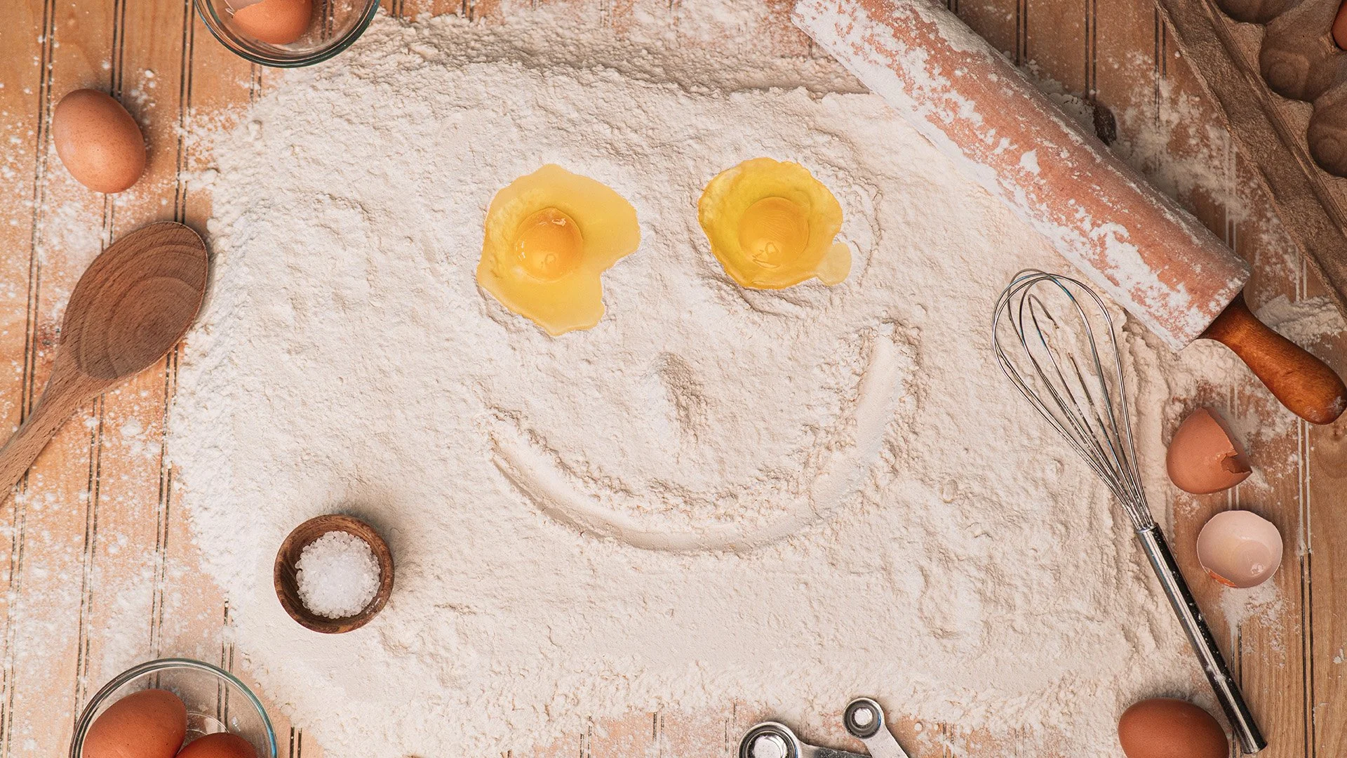 A smiley face made out of flower with eggs as the eyes