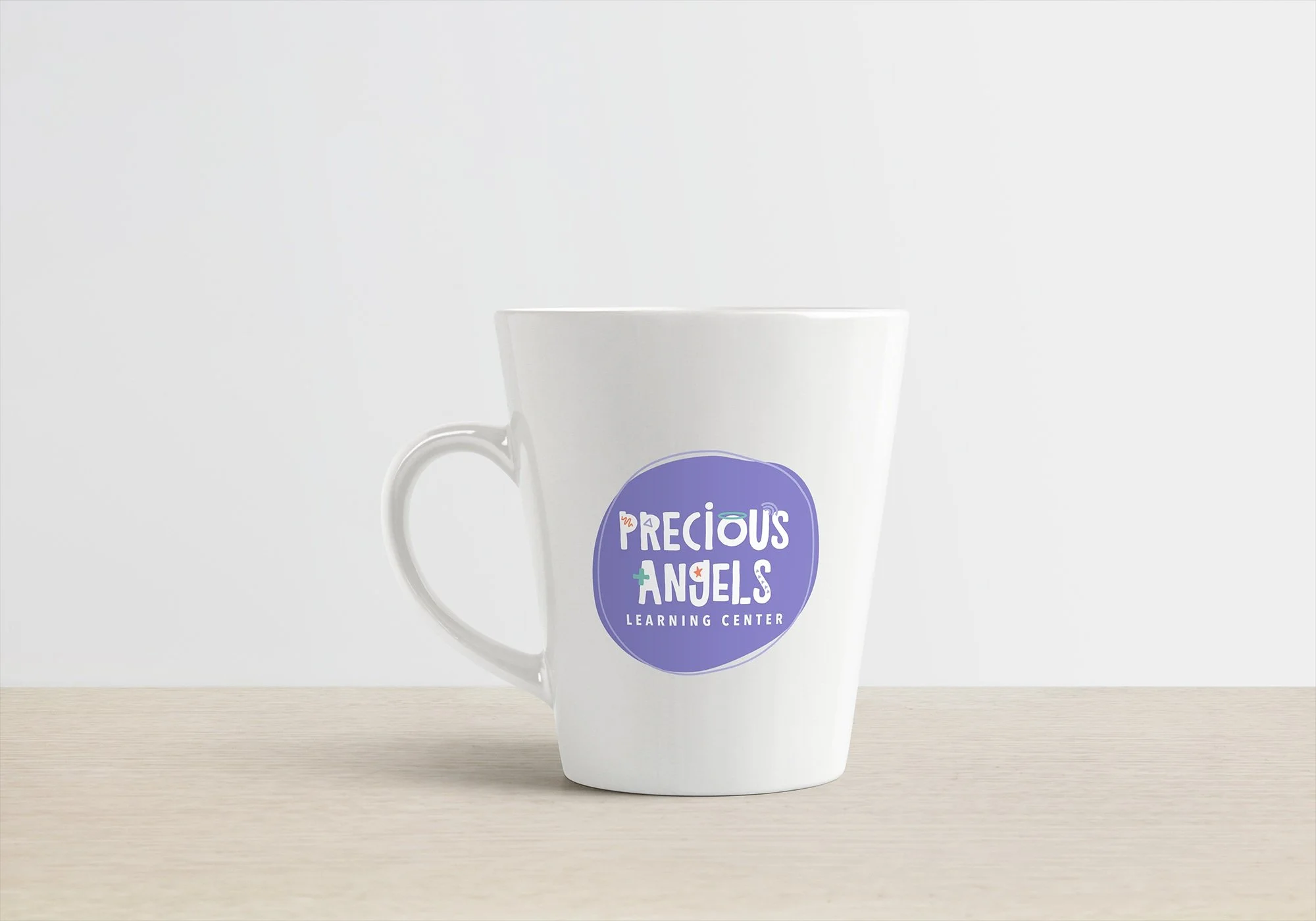Precious Angels logo on a coffee mug.