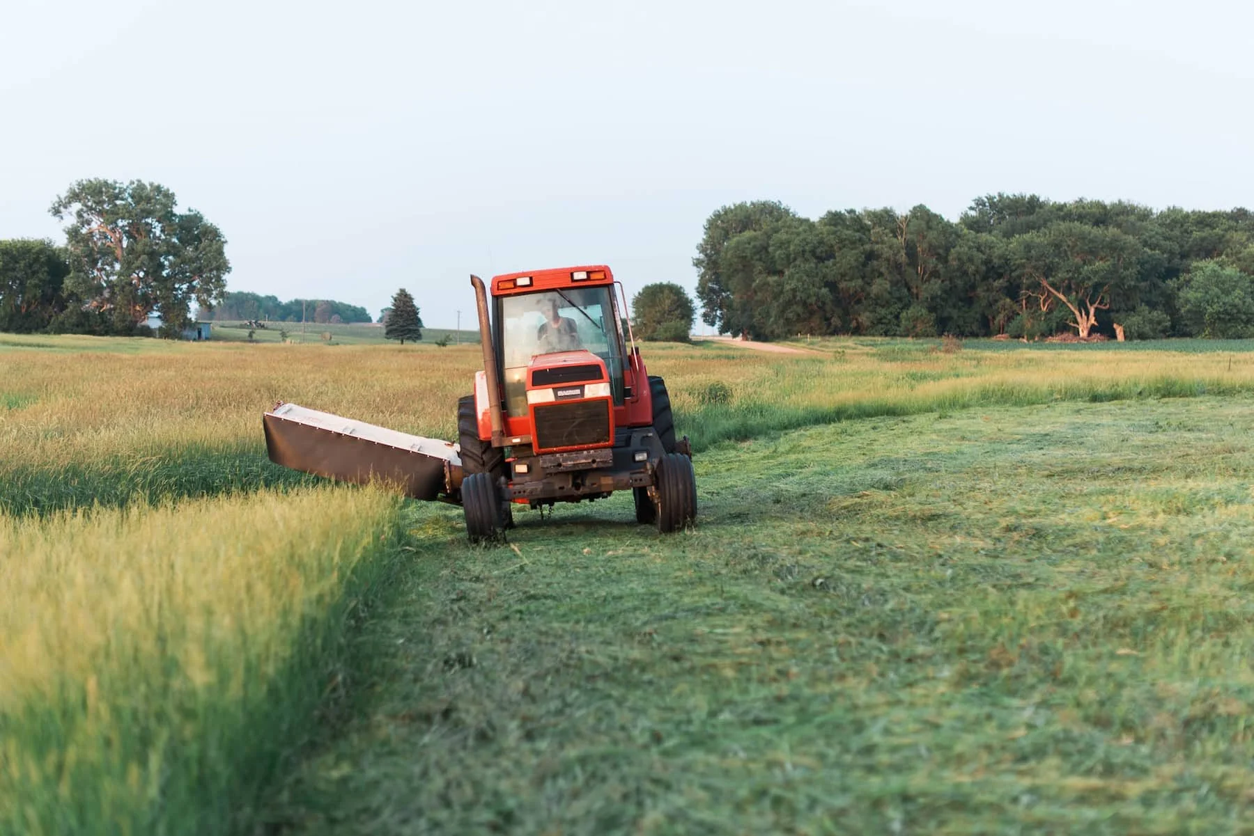 A red tractor in a field using The Rock Block.