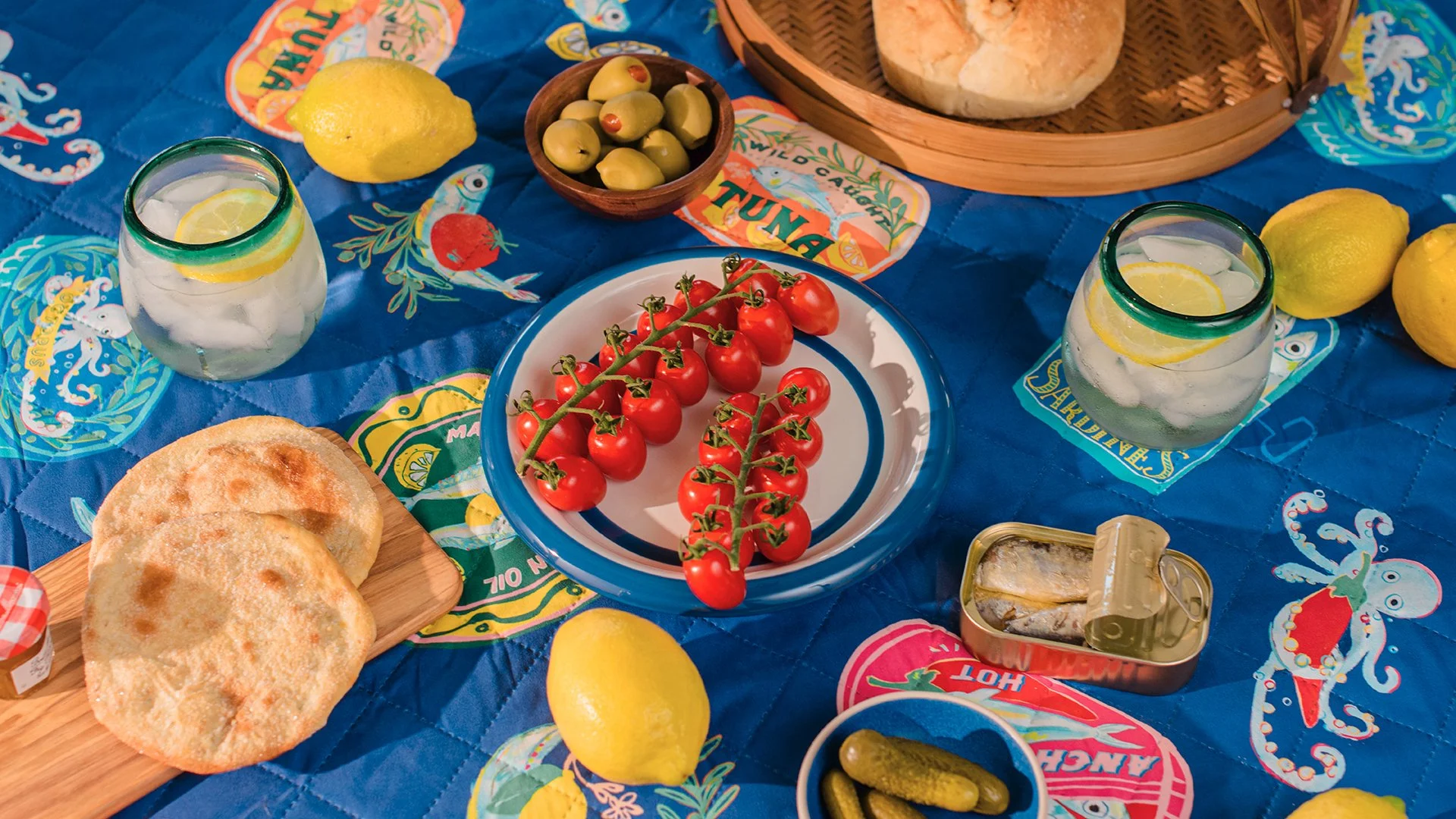 A summertime picnic with bread, fruits, and vegetables