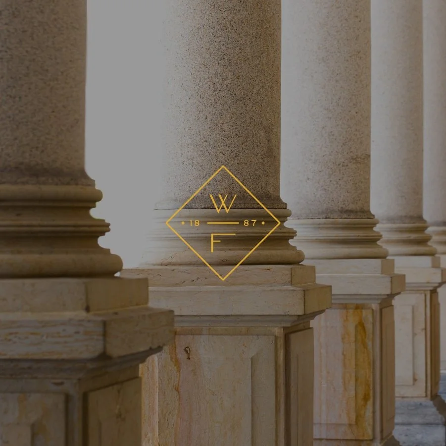 Woods Fuller logomark on background with pillars