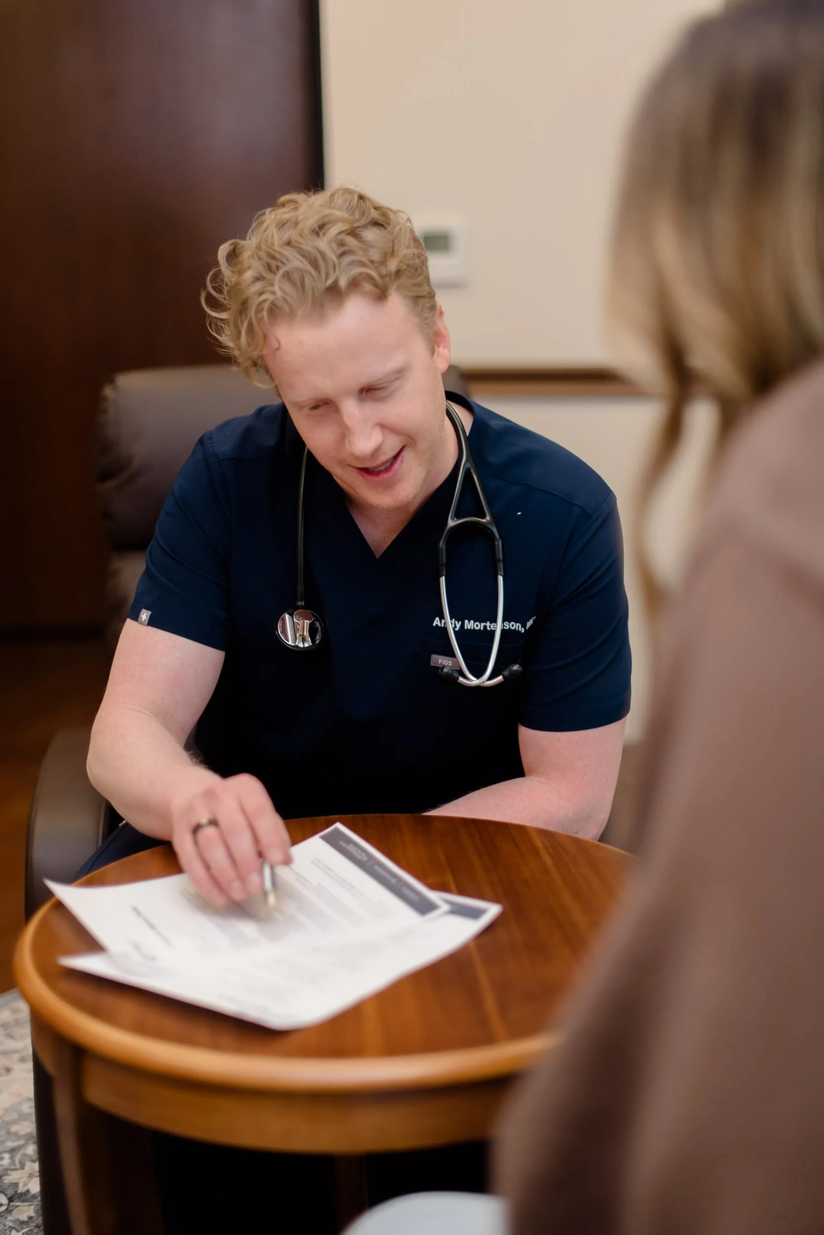 PAX Institute doctor showing paperwork to patient.