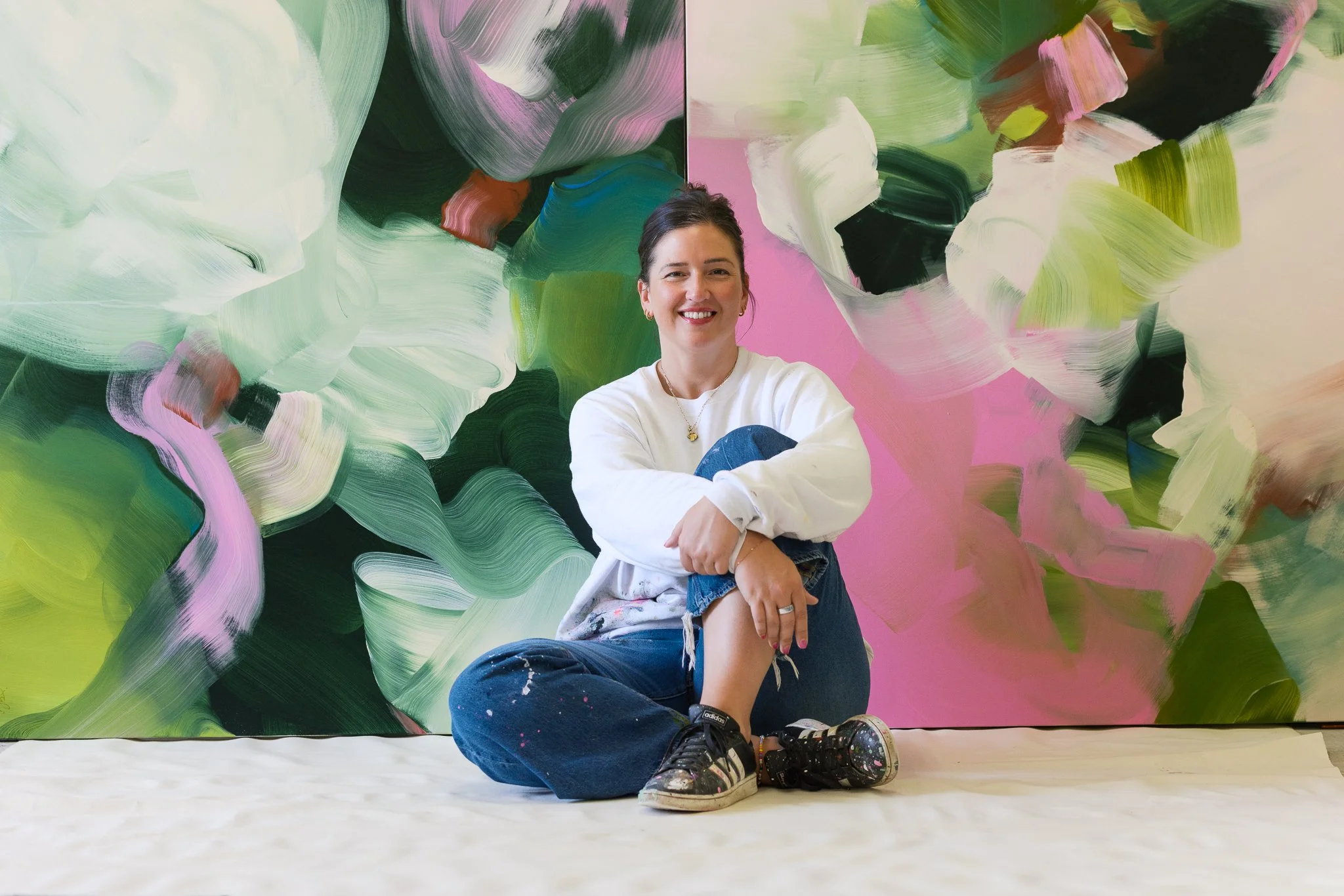 Artist Julie Hawkins with new abstract works in behind.