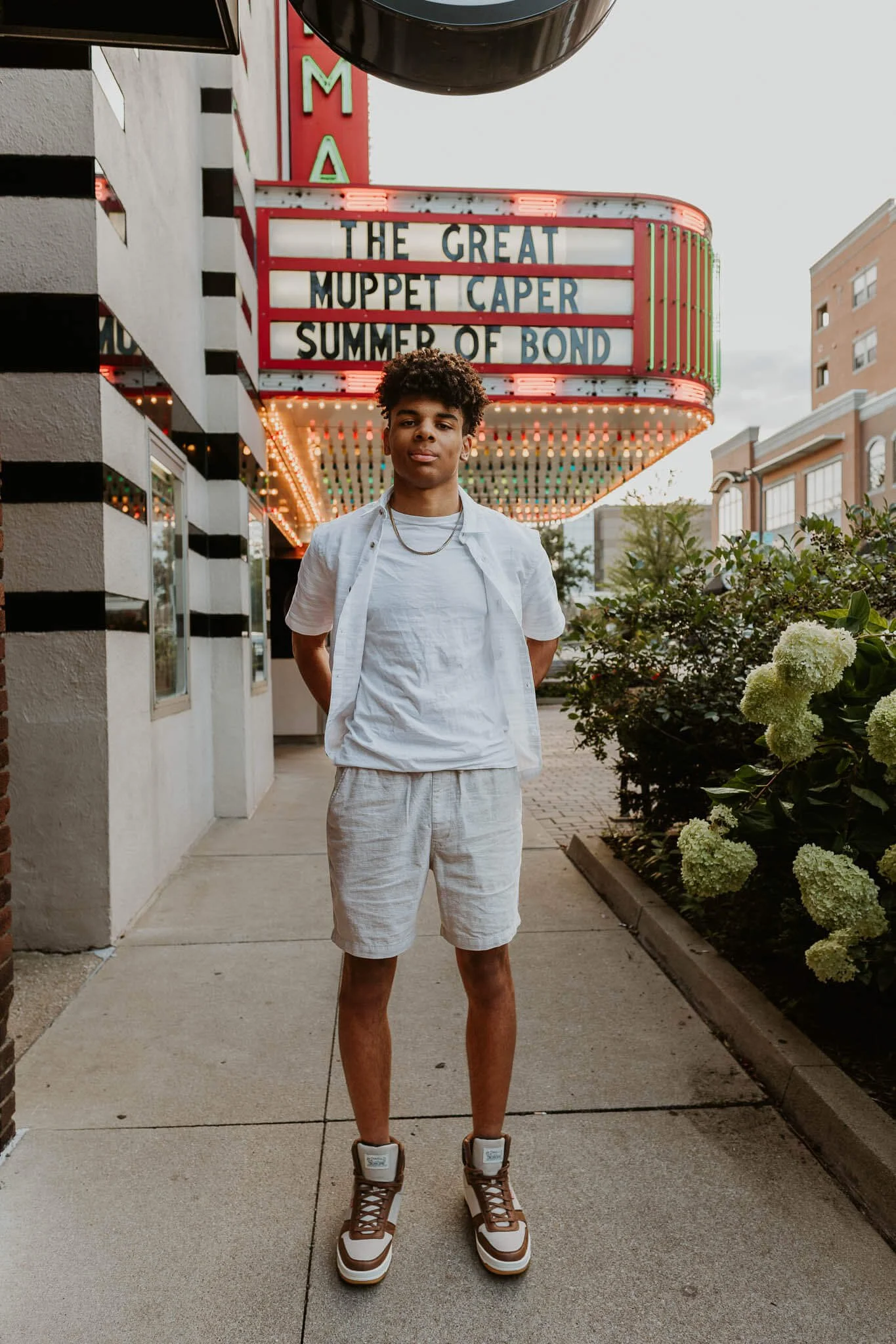 With the Normal Theatre in the background, an 18 year old boy stands informally with his hands in his pockets.