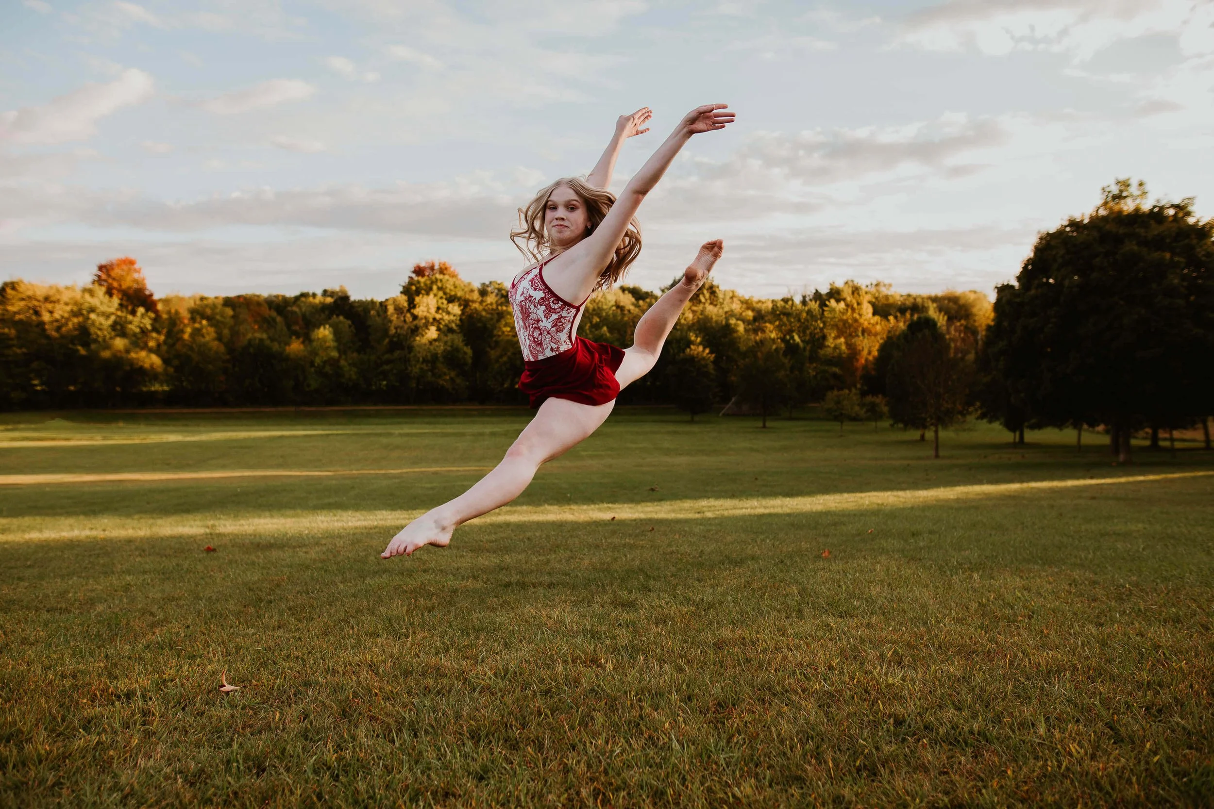 A talented dancer leaps in the air at Ewing Park III in Bloomington IL