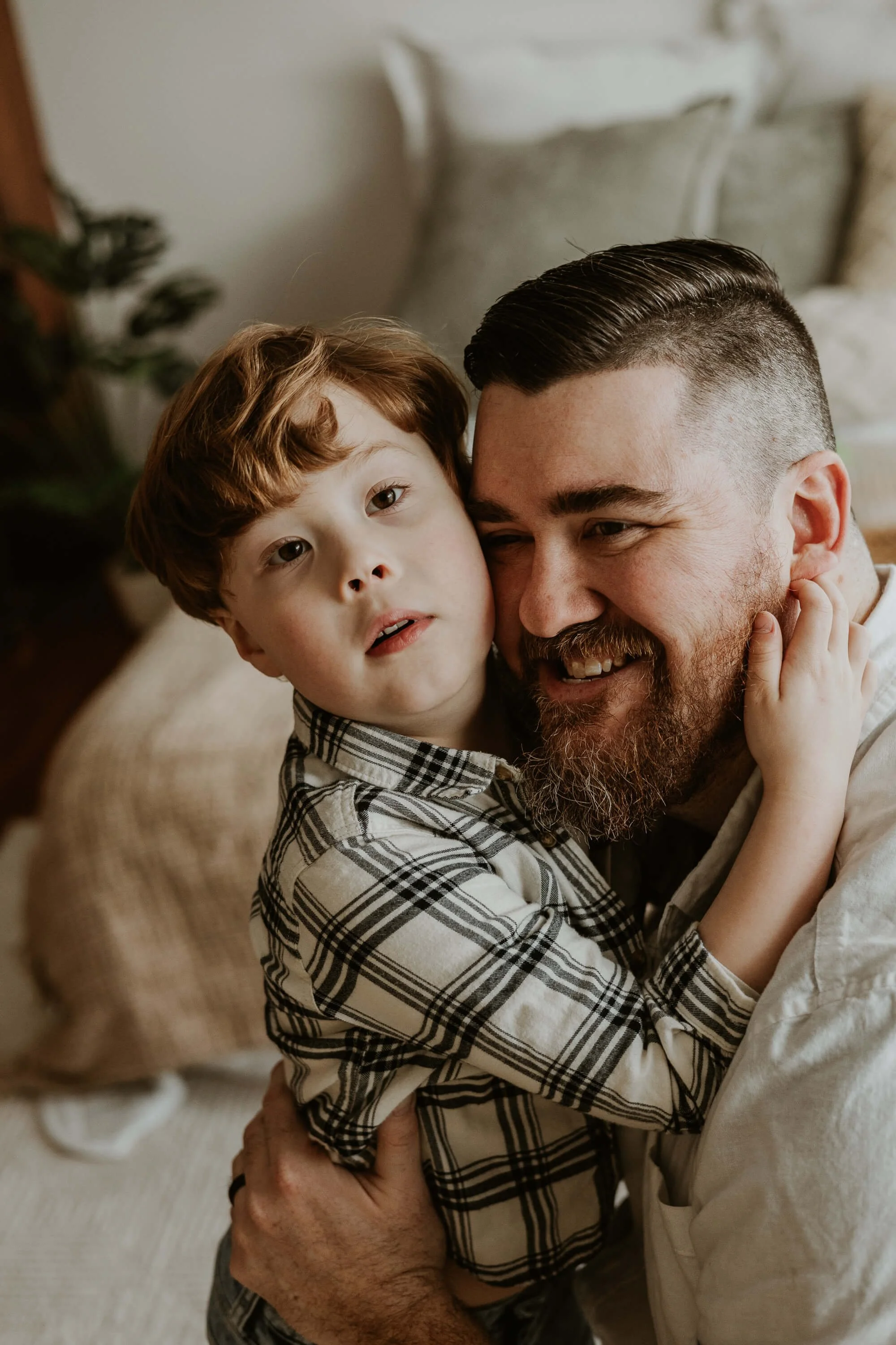 A son hugs his father's neck