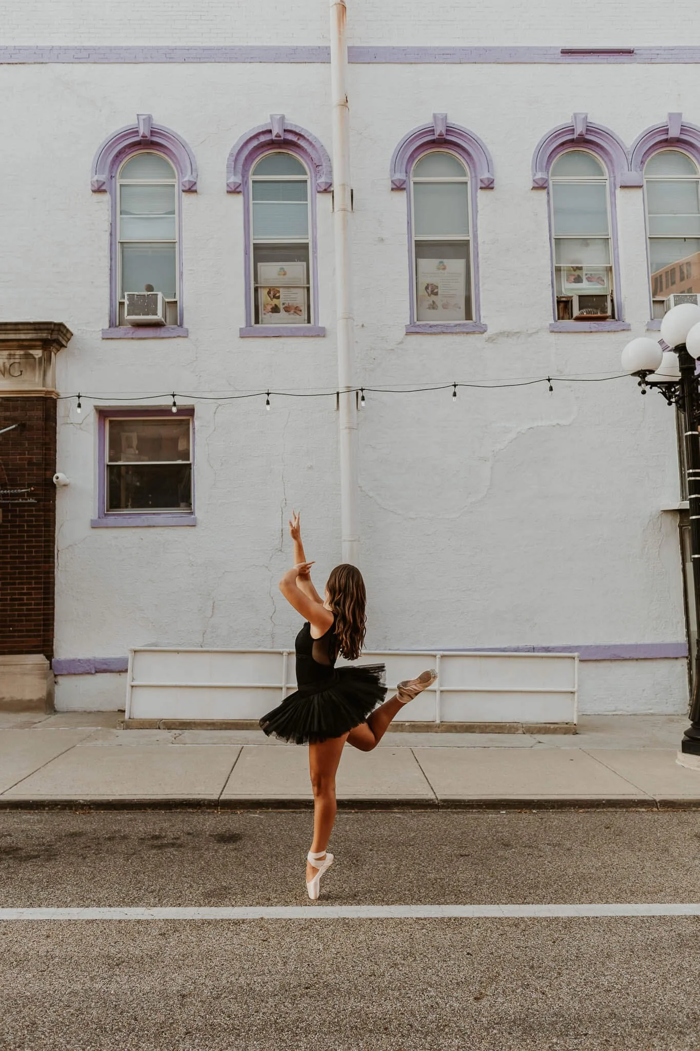 A ballerina holds a pose en pointe in Downtown Bloomington IL