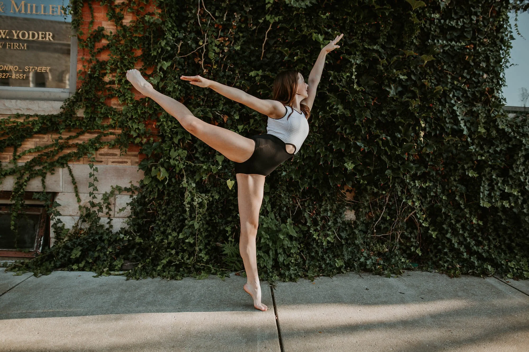 Bare feet won't stop this dancer from holding a graceful ballet pose on the sidewalk in Downtown Bloomington.