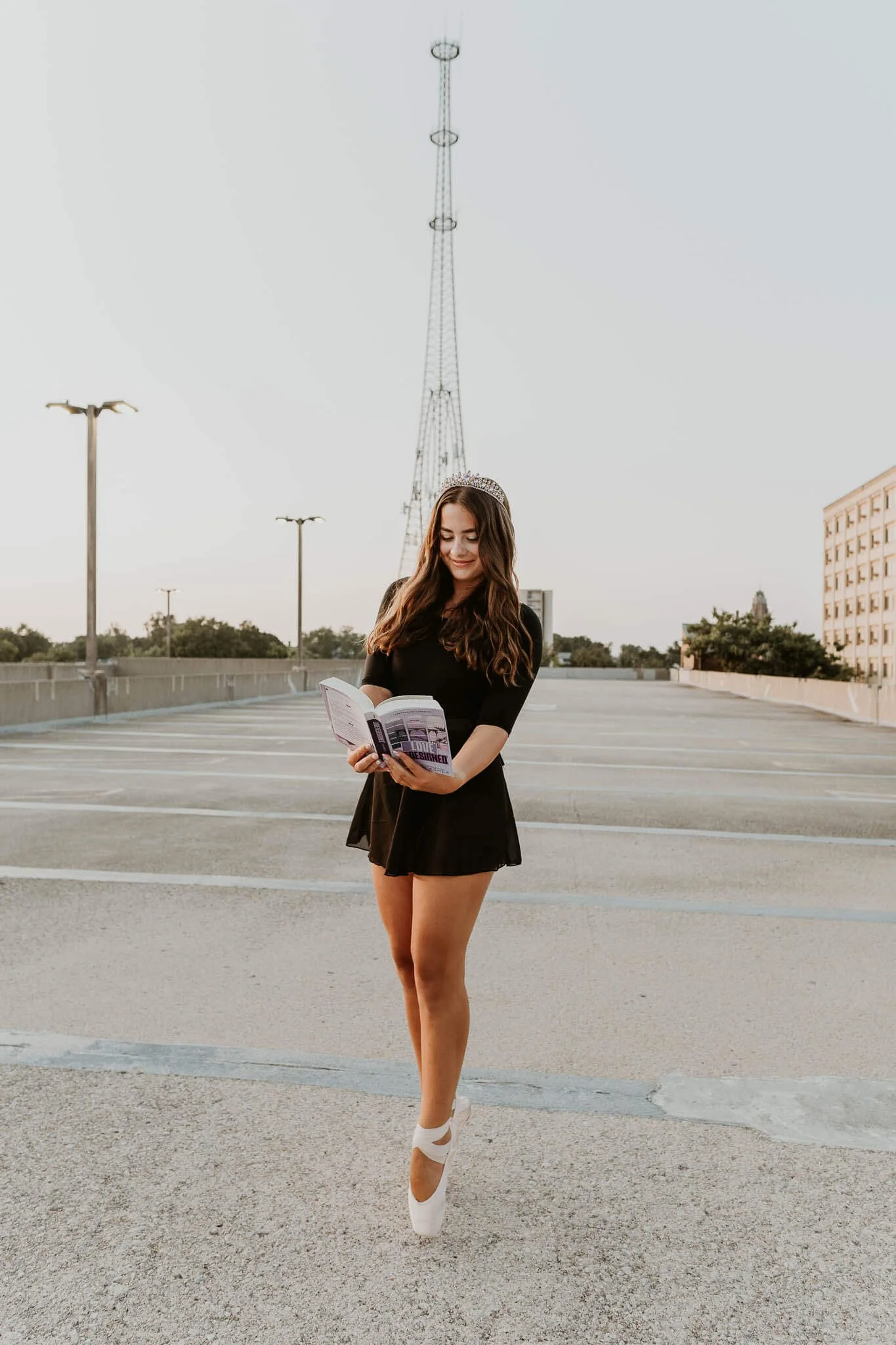 A ballerina en pointe holds her favorite book in hand