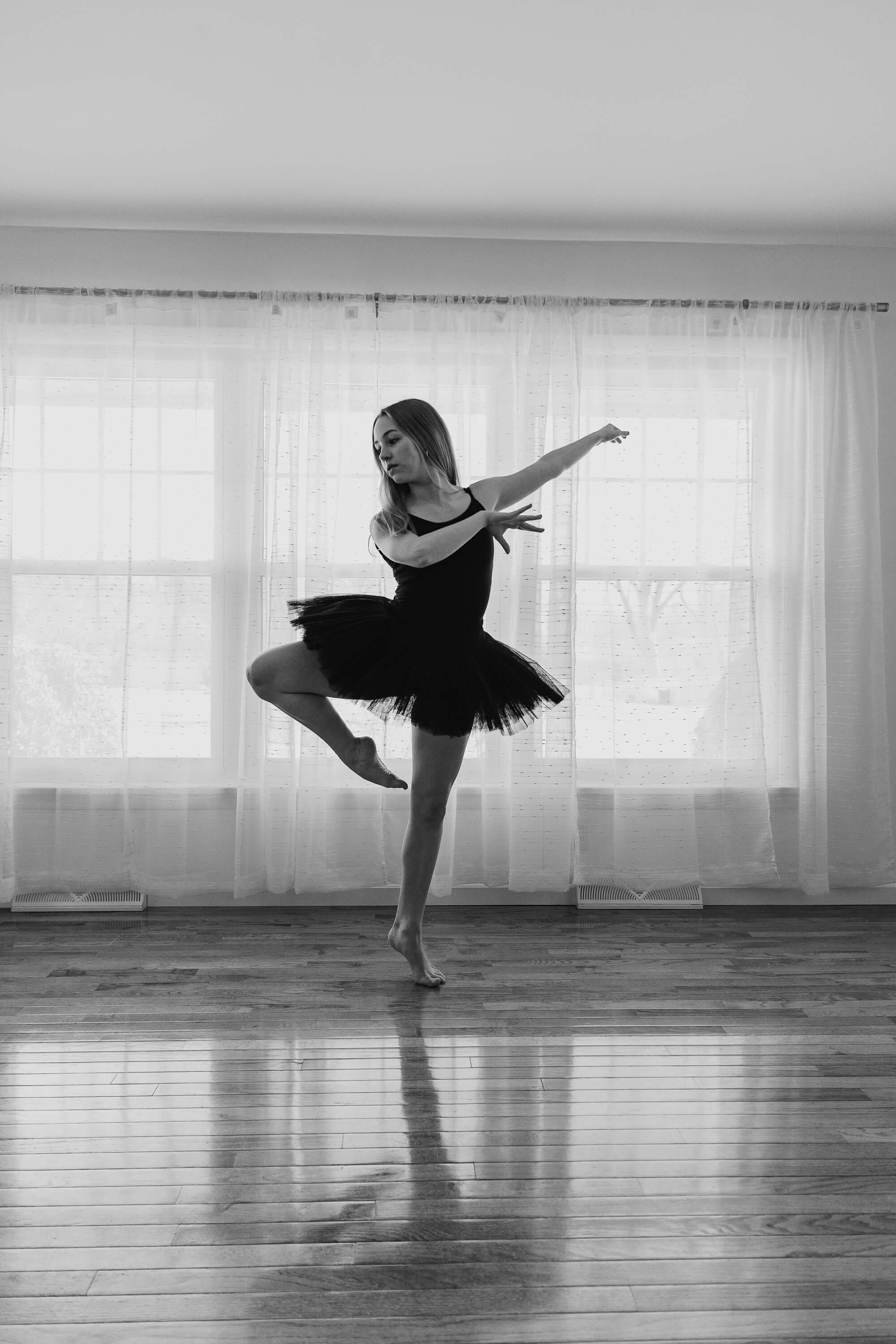 A black and white image of a ballet dancer wearing a traditional tutu.
