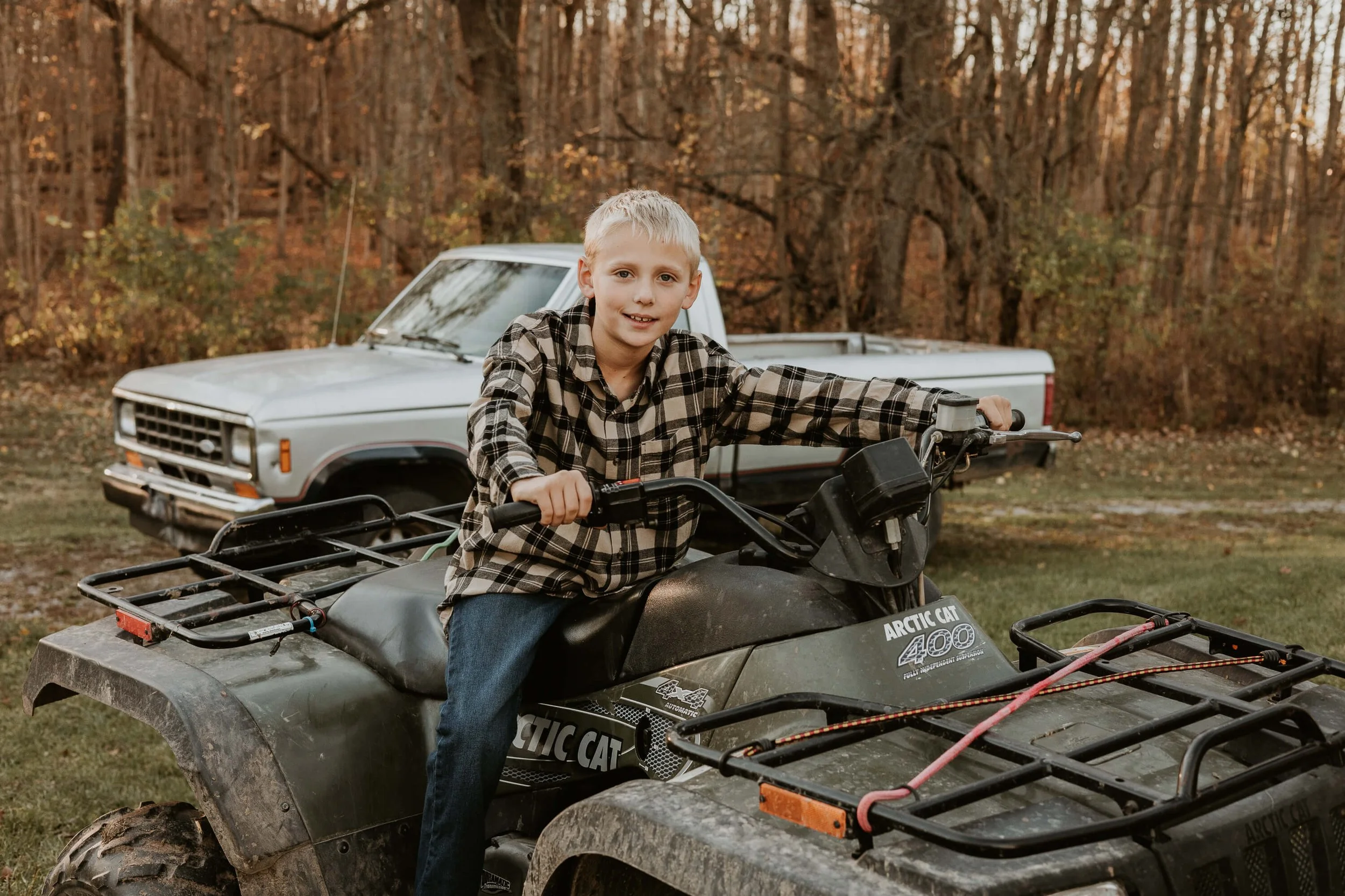 A ten-year-old boy prepares to drive his dad's four wheeler