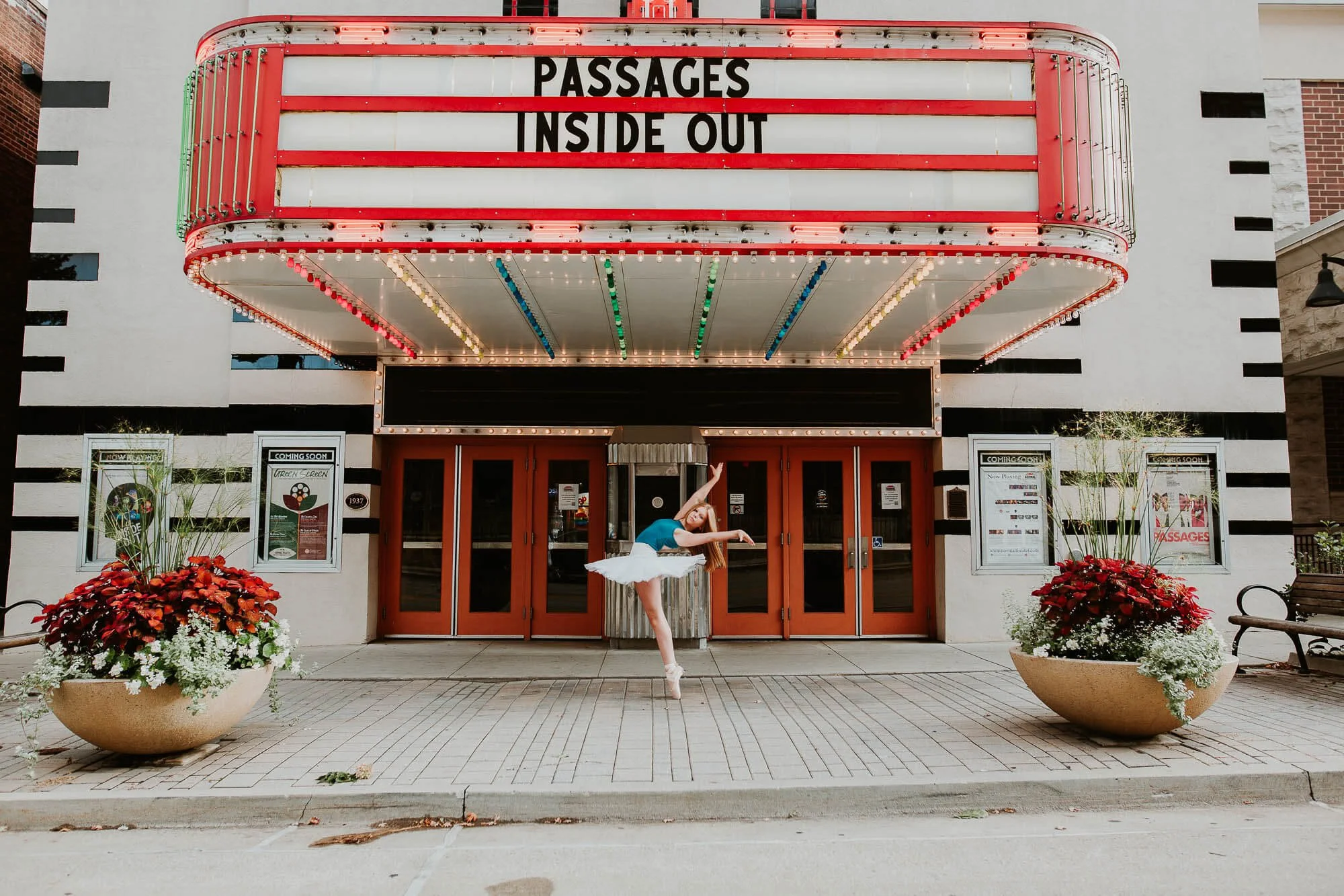 A dancer strikes a pose in front of The Normal Theatre in Uptown Normal