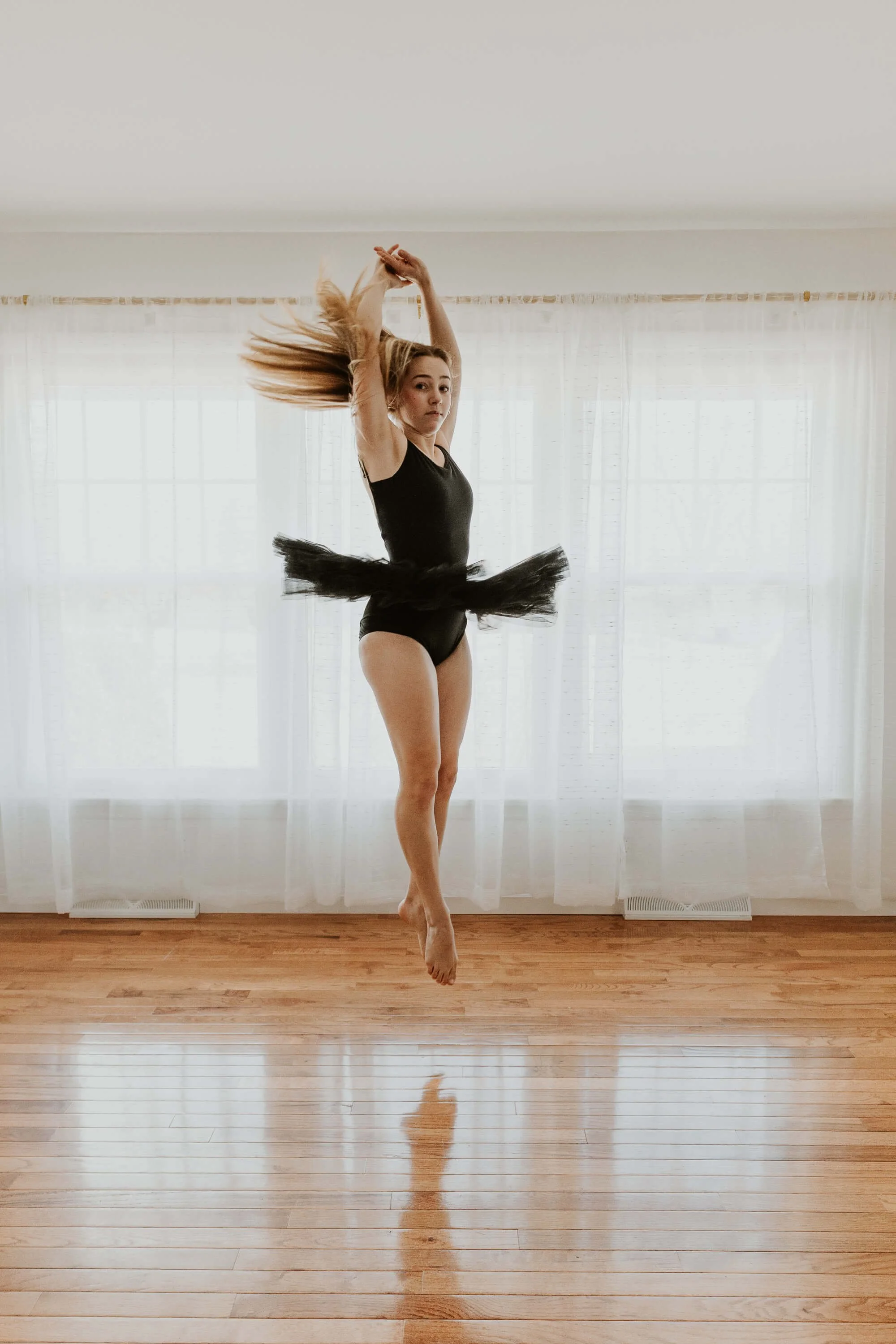 A graceful spin from a dancer wearing a black tutu during her Bloomington IL studio session.