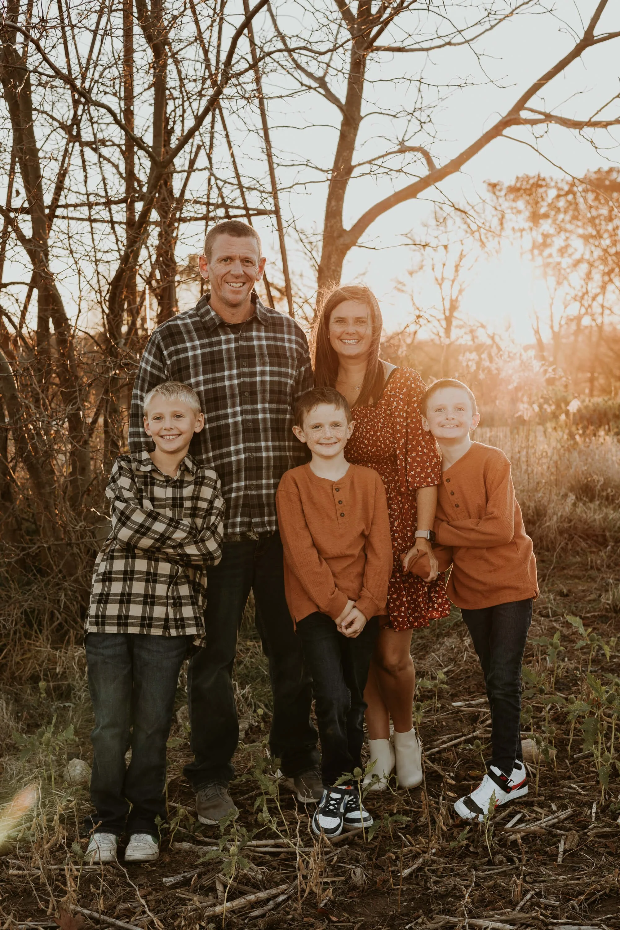 A family poses for their lifestyle session during golden hour with Liz Walsh Photography 