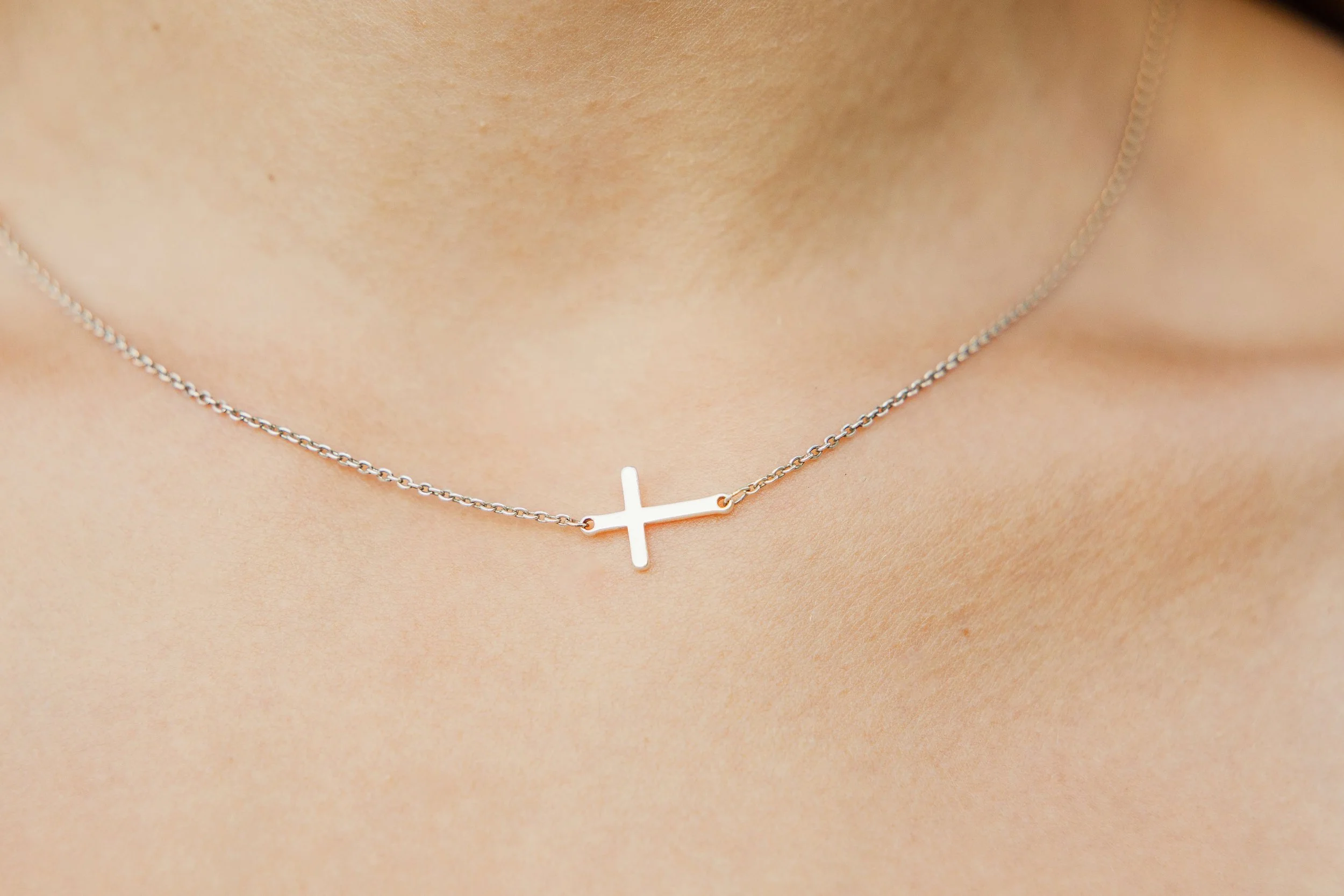 Detail shot of senior girl's meaningful jewelry during senior portrait session in Normal Illinois