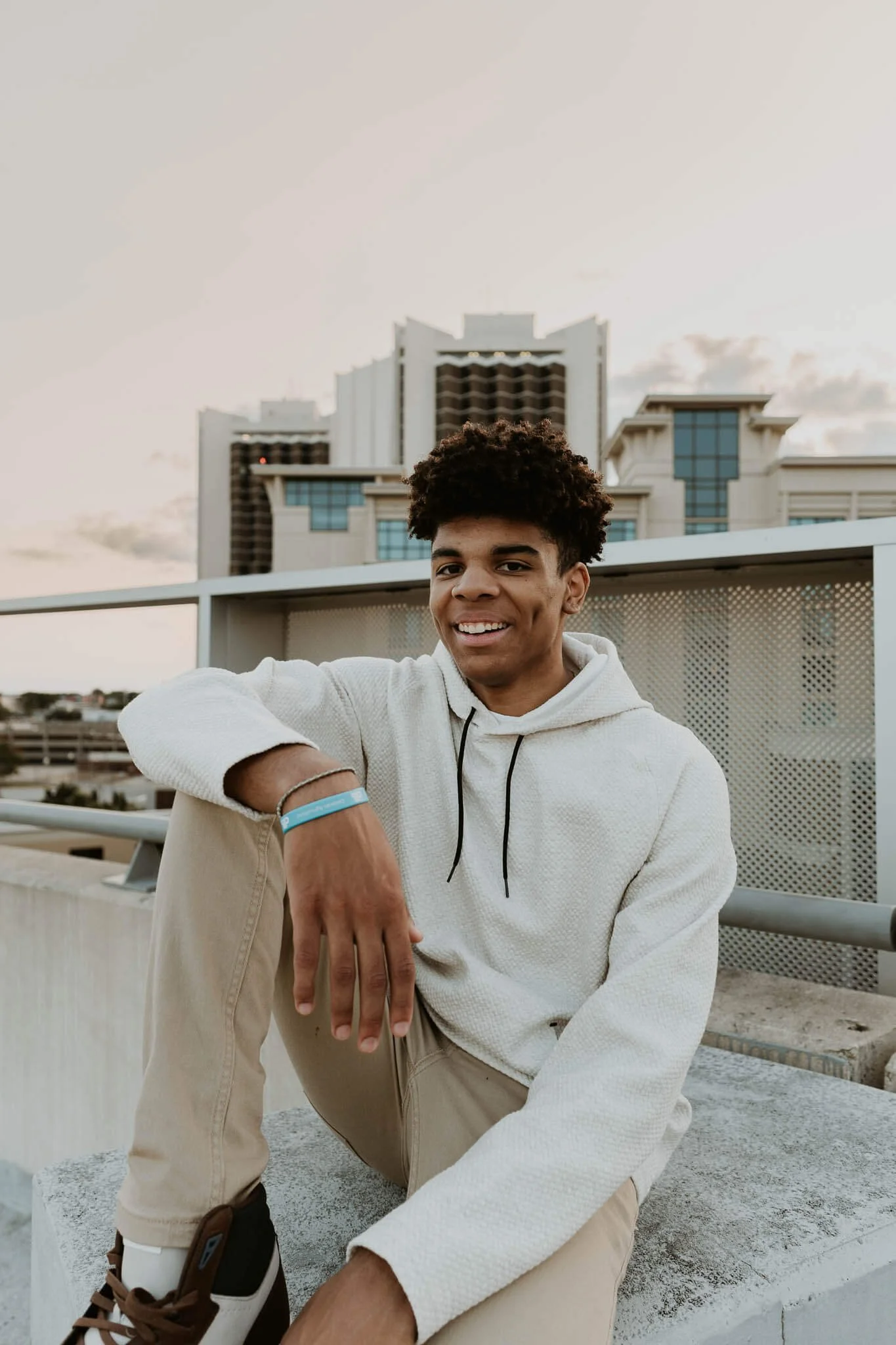 A senior from Normal Community High School sits casually atop the parking deck in Uptown Normal.