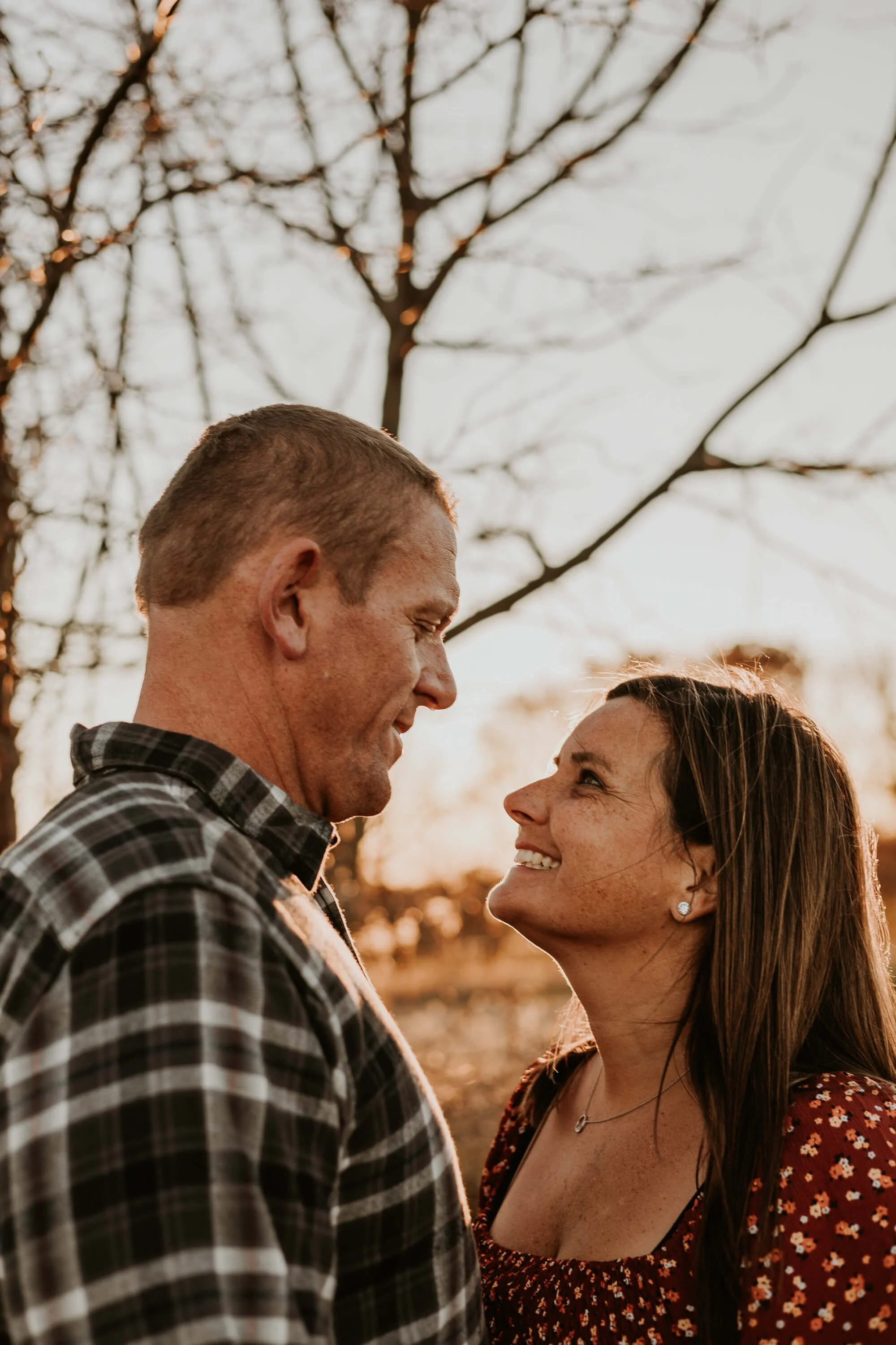 A husband gazes down at his wife, close enough for an embrace