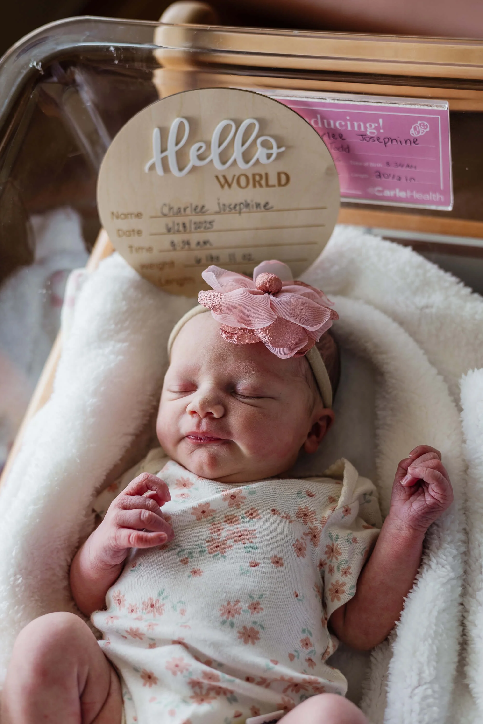A baby sleeps in her hospital bassinet