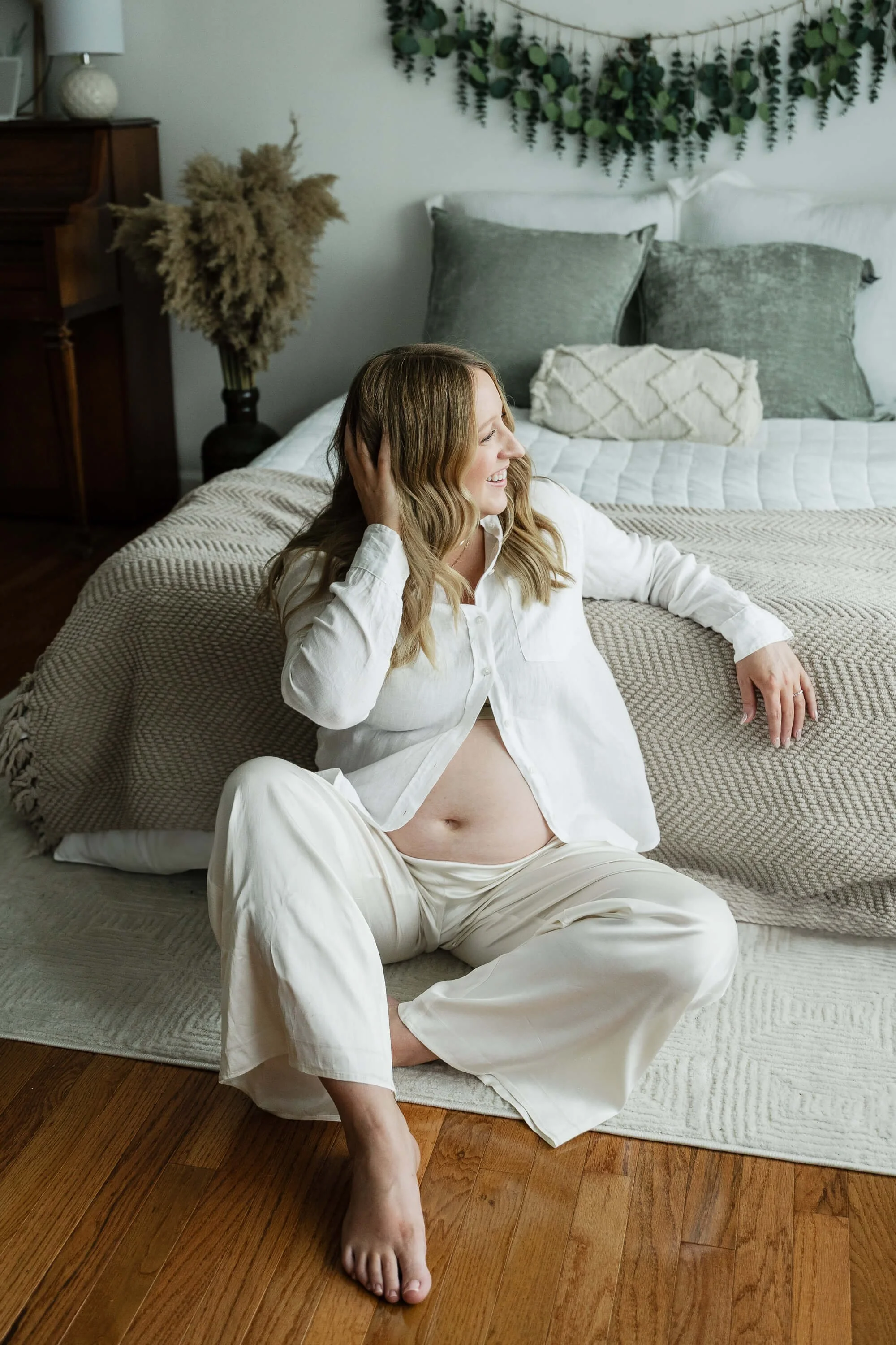 Mom-to-be Makenzie laughs during her studio session with Liz Walsh Photography