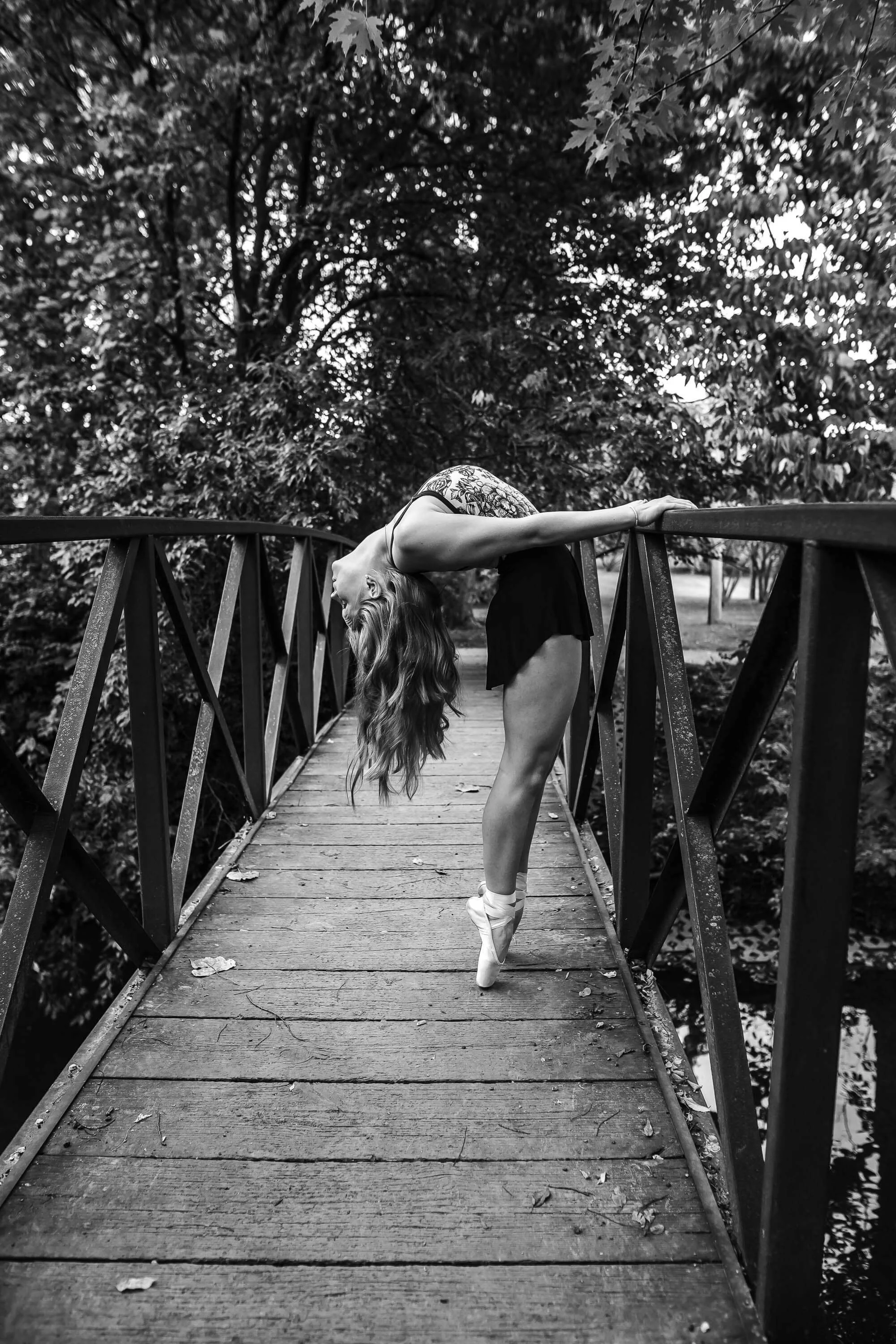 a black and white of a dancer showing her flexibility as she bends backwards