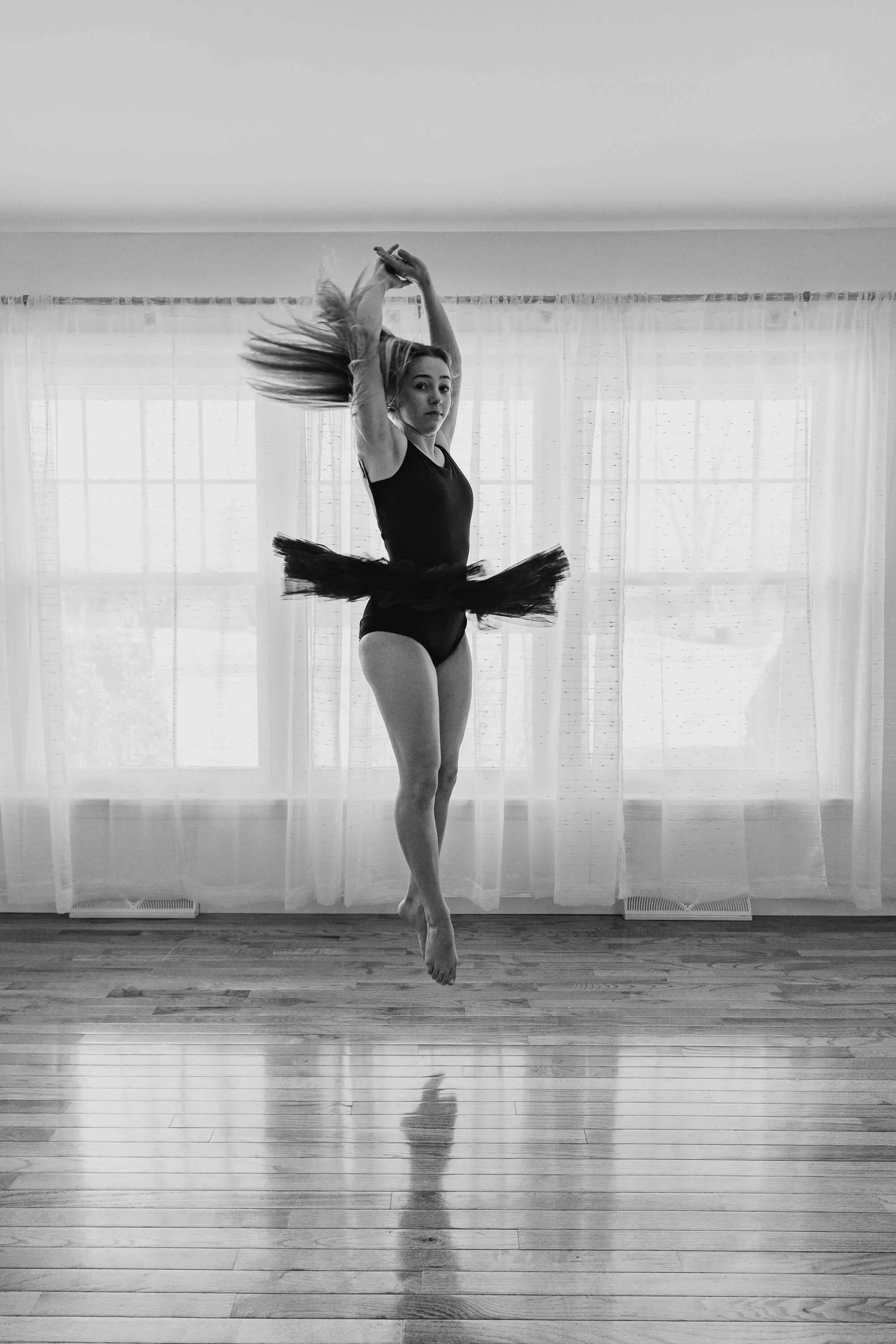 A black and white image of a dancer in a spin.