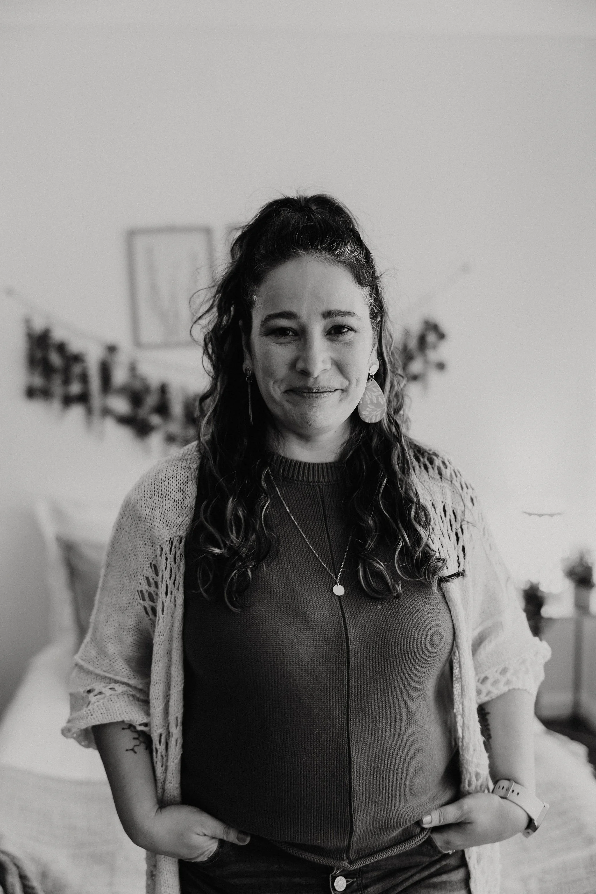 A black and white image of Liz Walsh smiling, looking directly into the camera