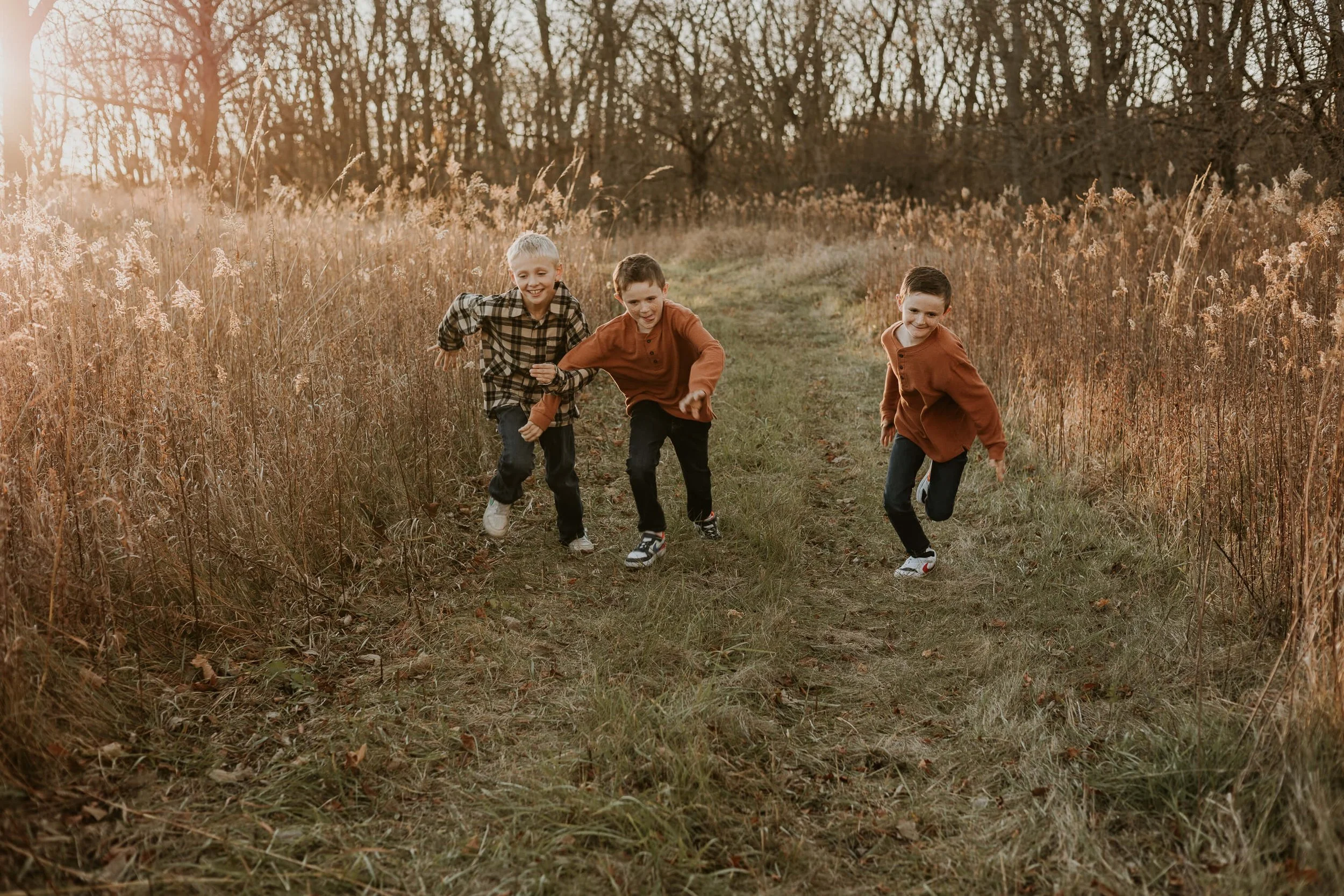 Brothers race down a mowed path to see who will reach their parents first