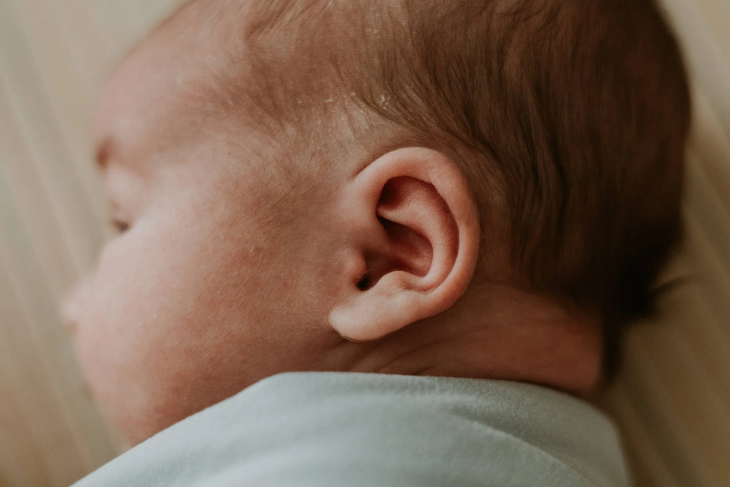 A close up of a newborn's ear