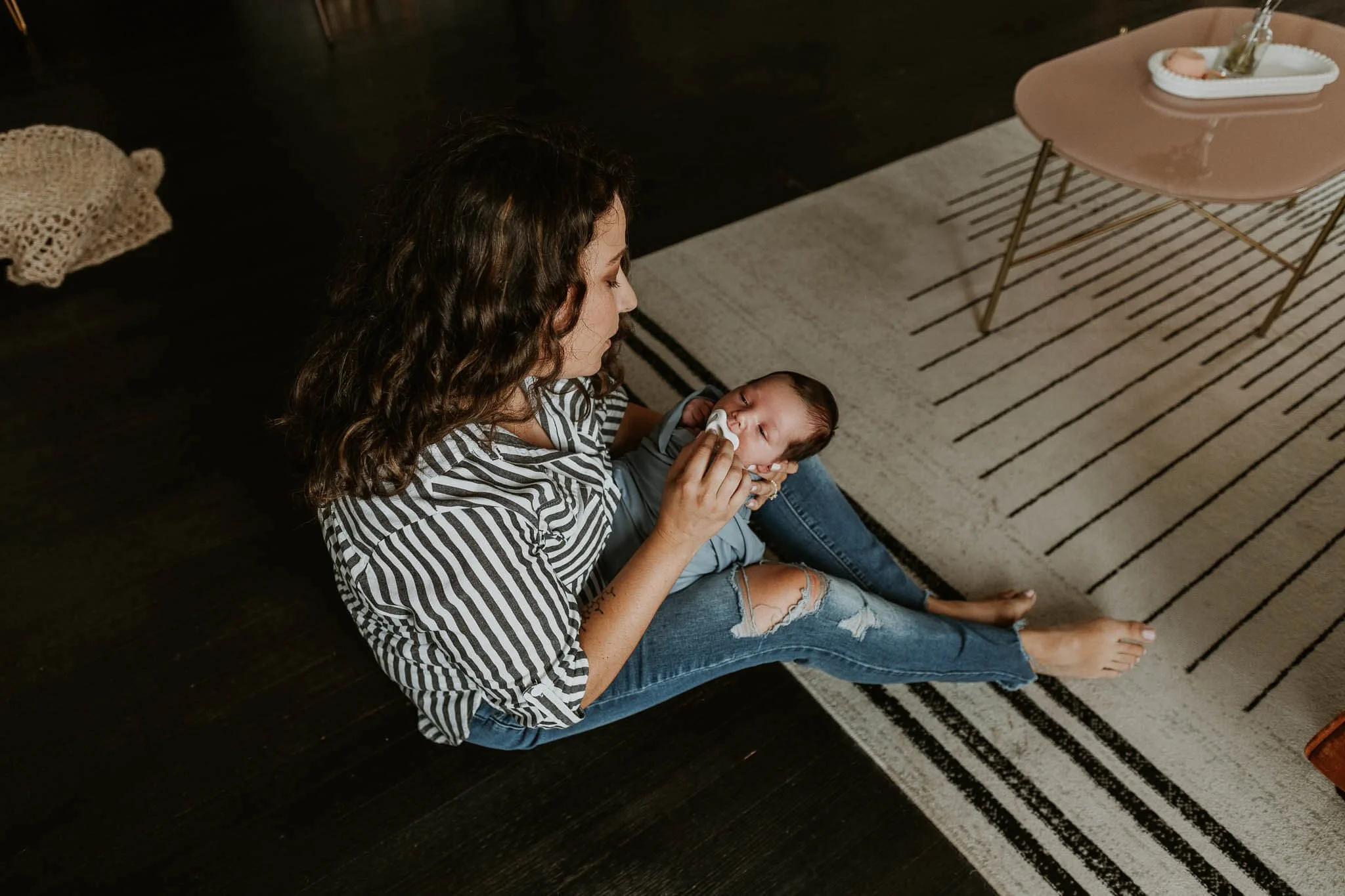 Liz Walsh holds a newborn working to get him to sleep during his studio session
