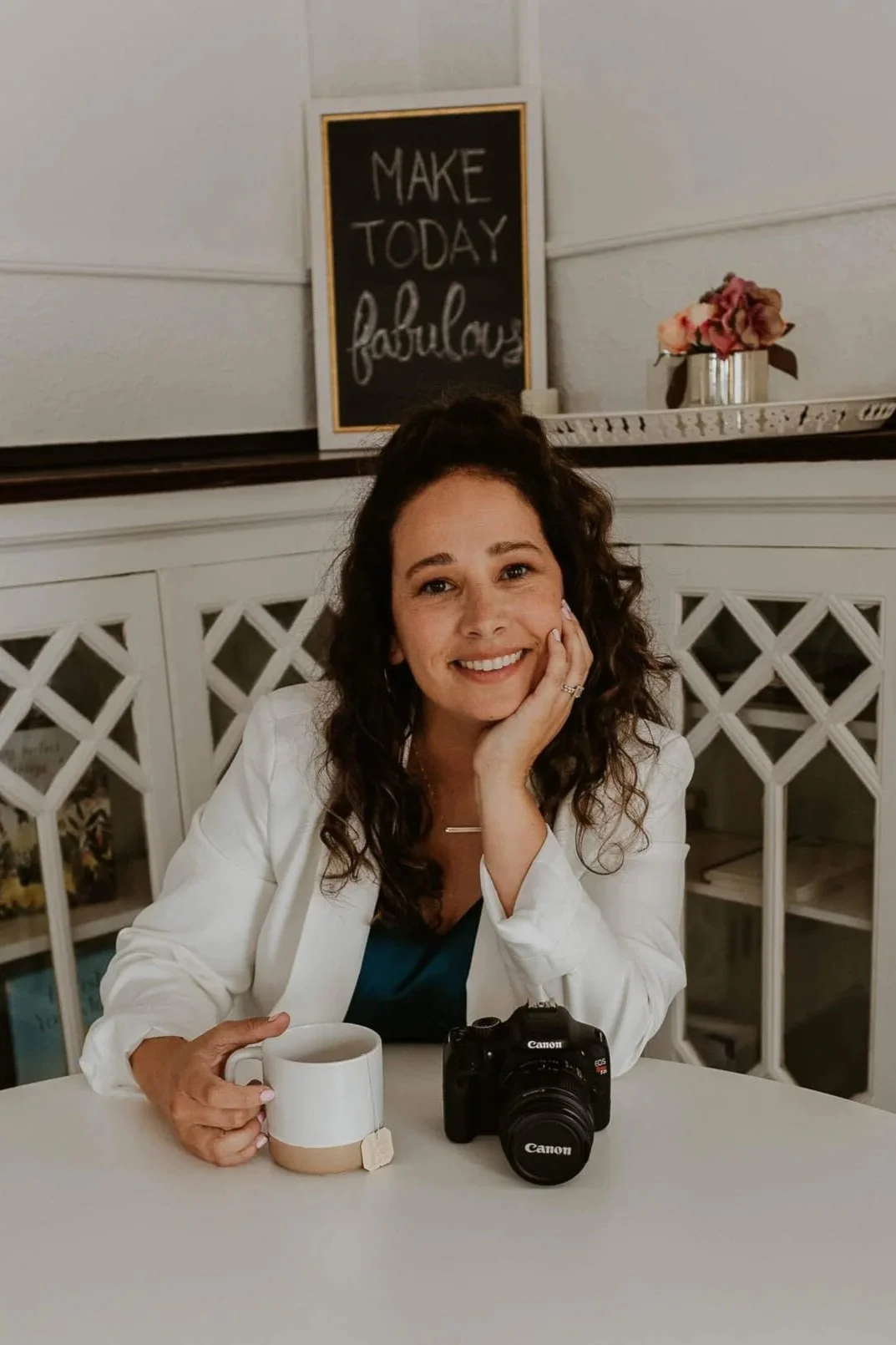 Liz Walsh with a cup of chai and her Canon camera