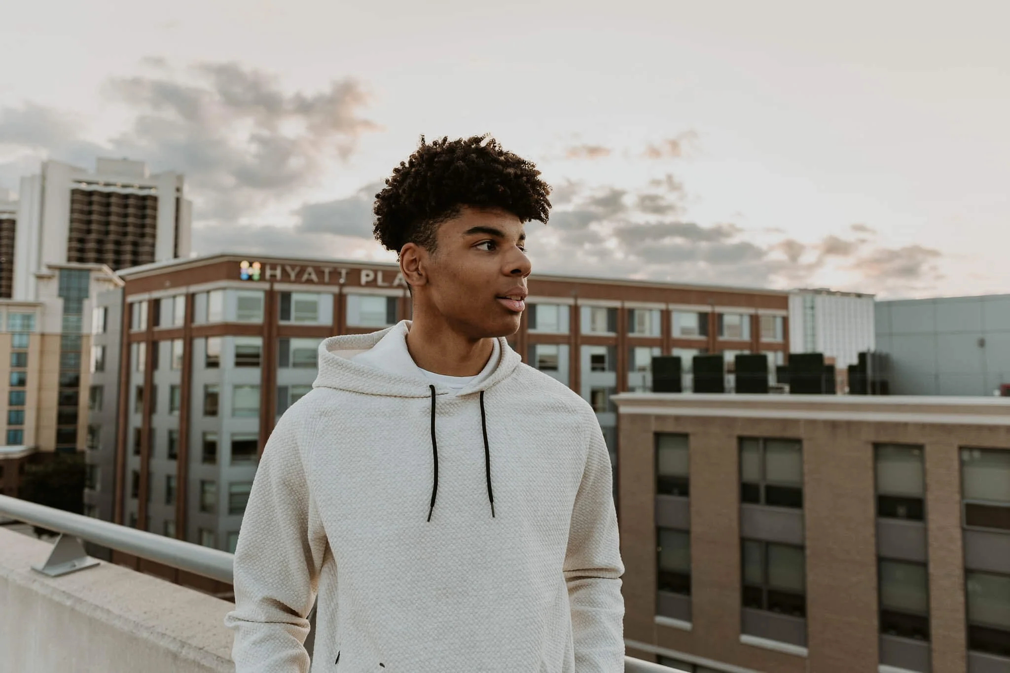 A profile shot of a teen boy atop the parking deck of Normal Station